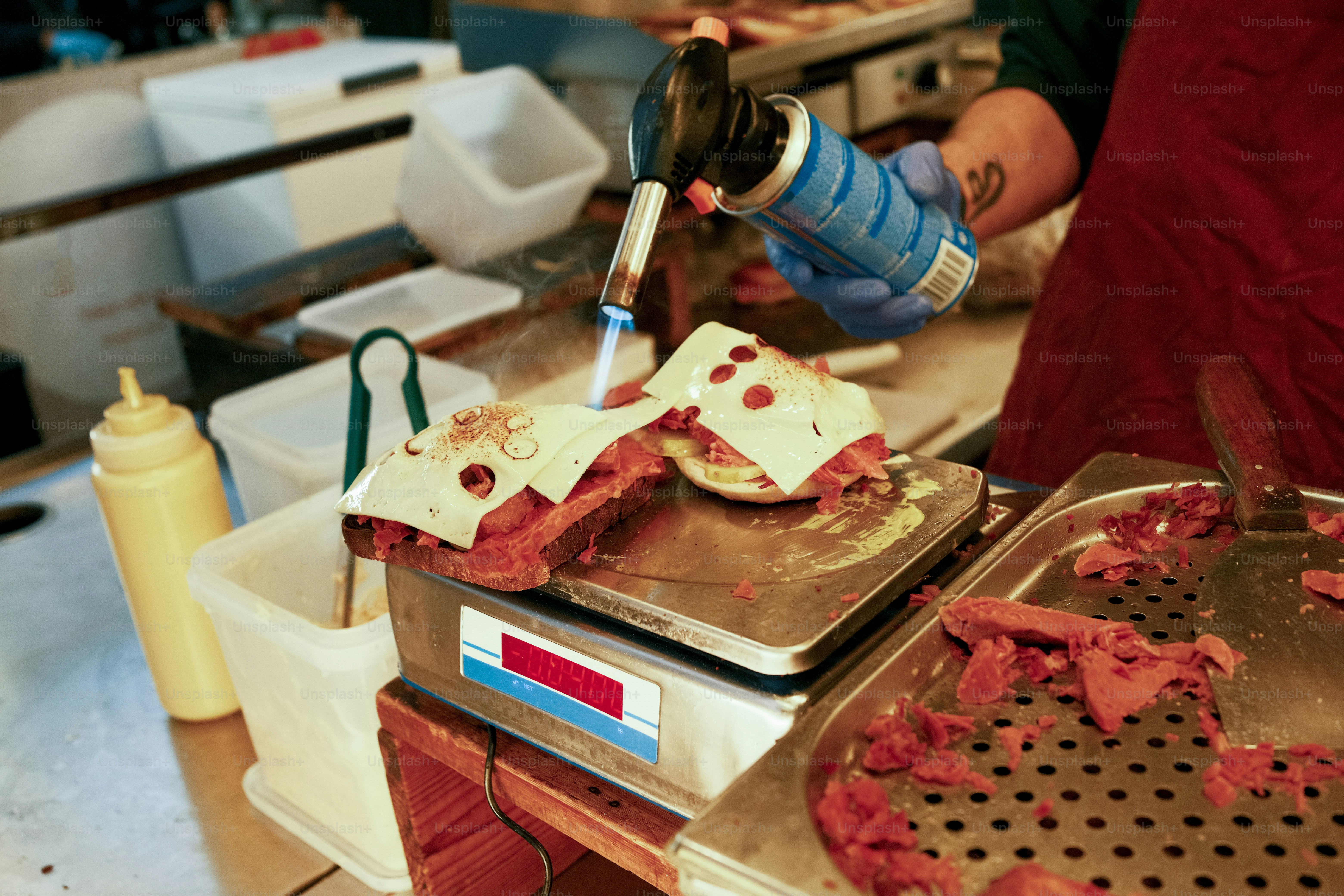 A person in a kitchen preparing food on a pan