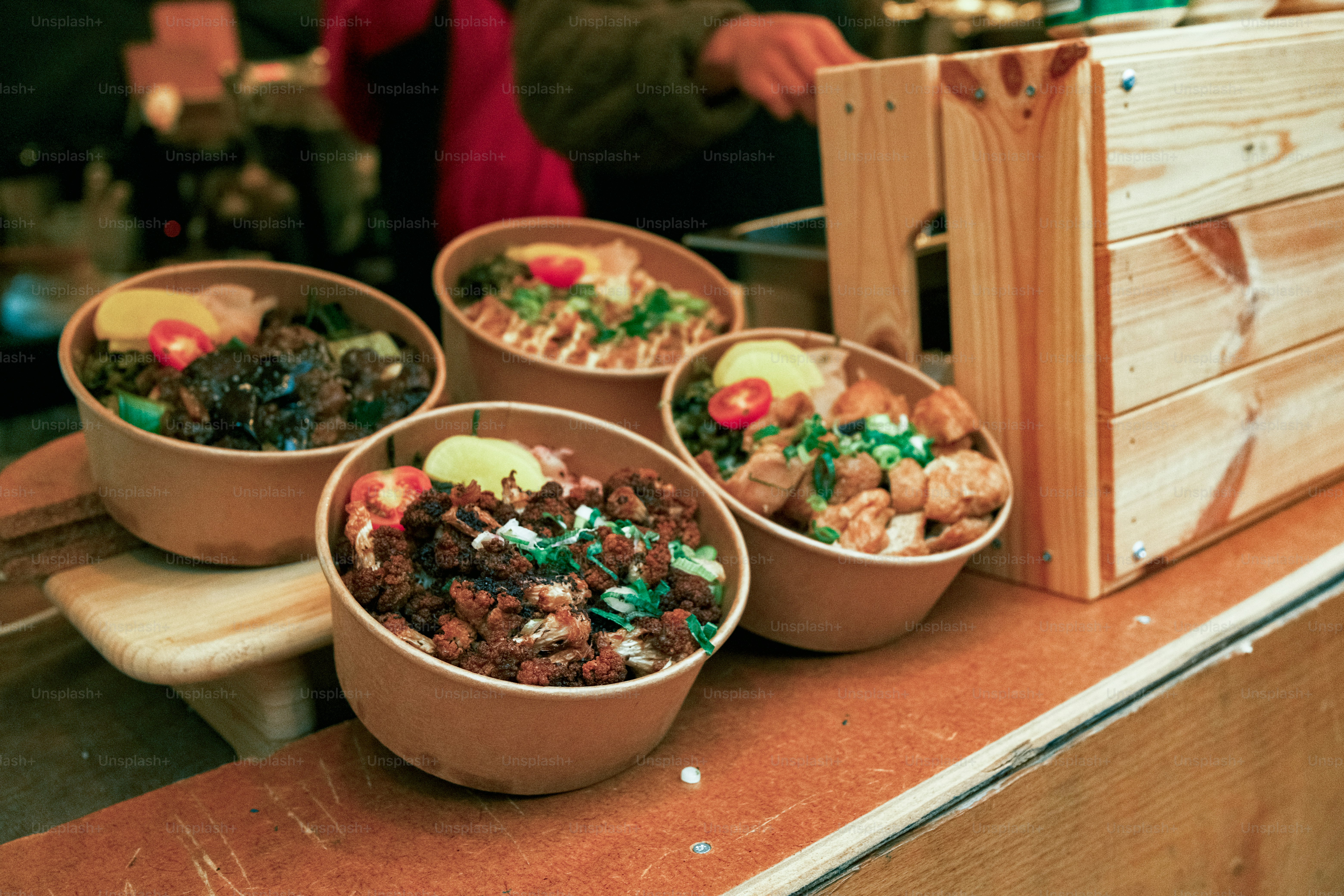 A table topped with bowls of food next to a wooden box