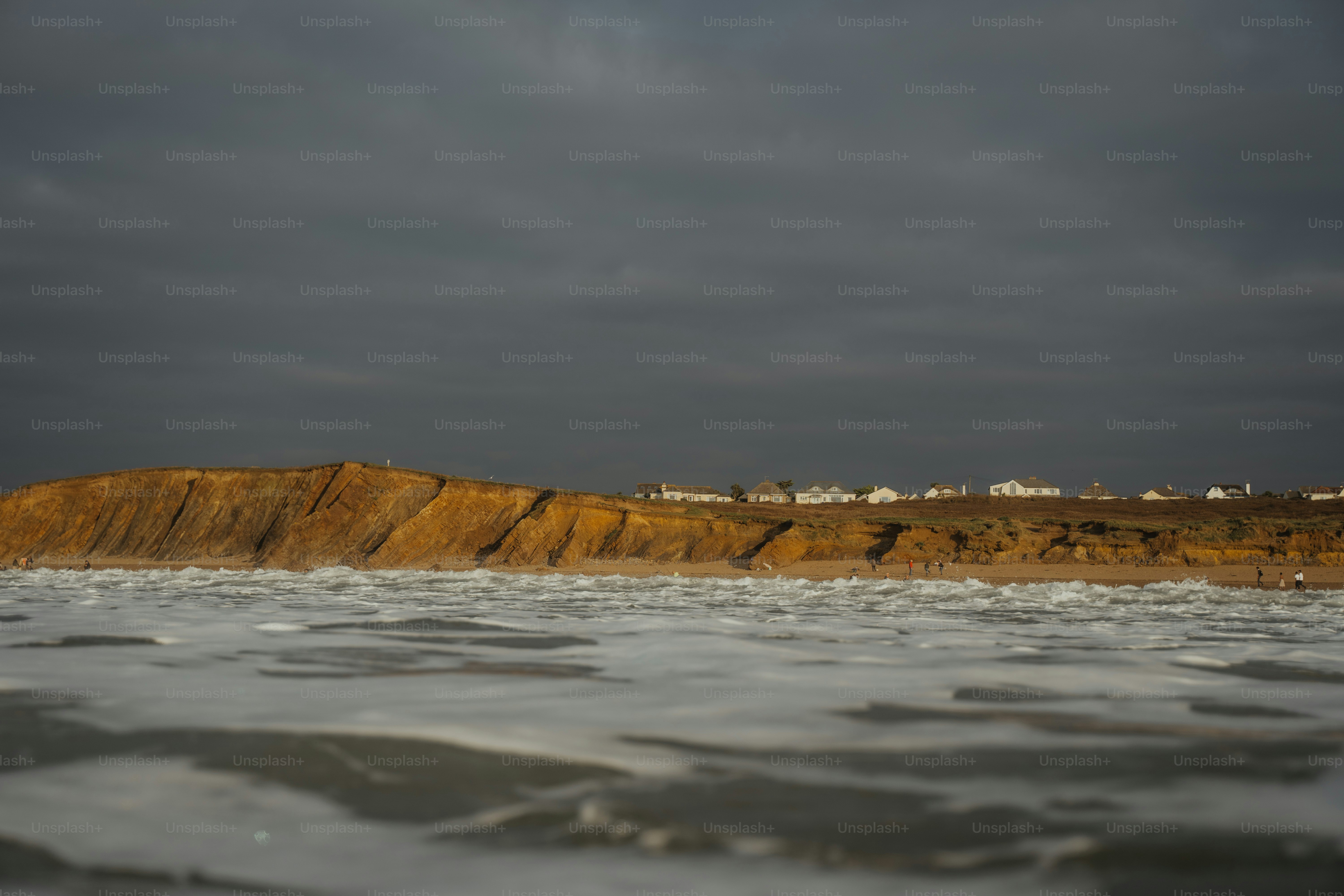 A body of water with a hill in the background