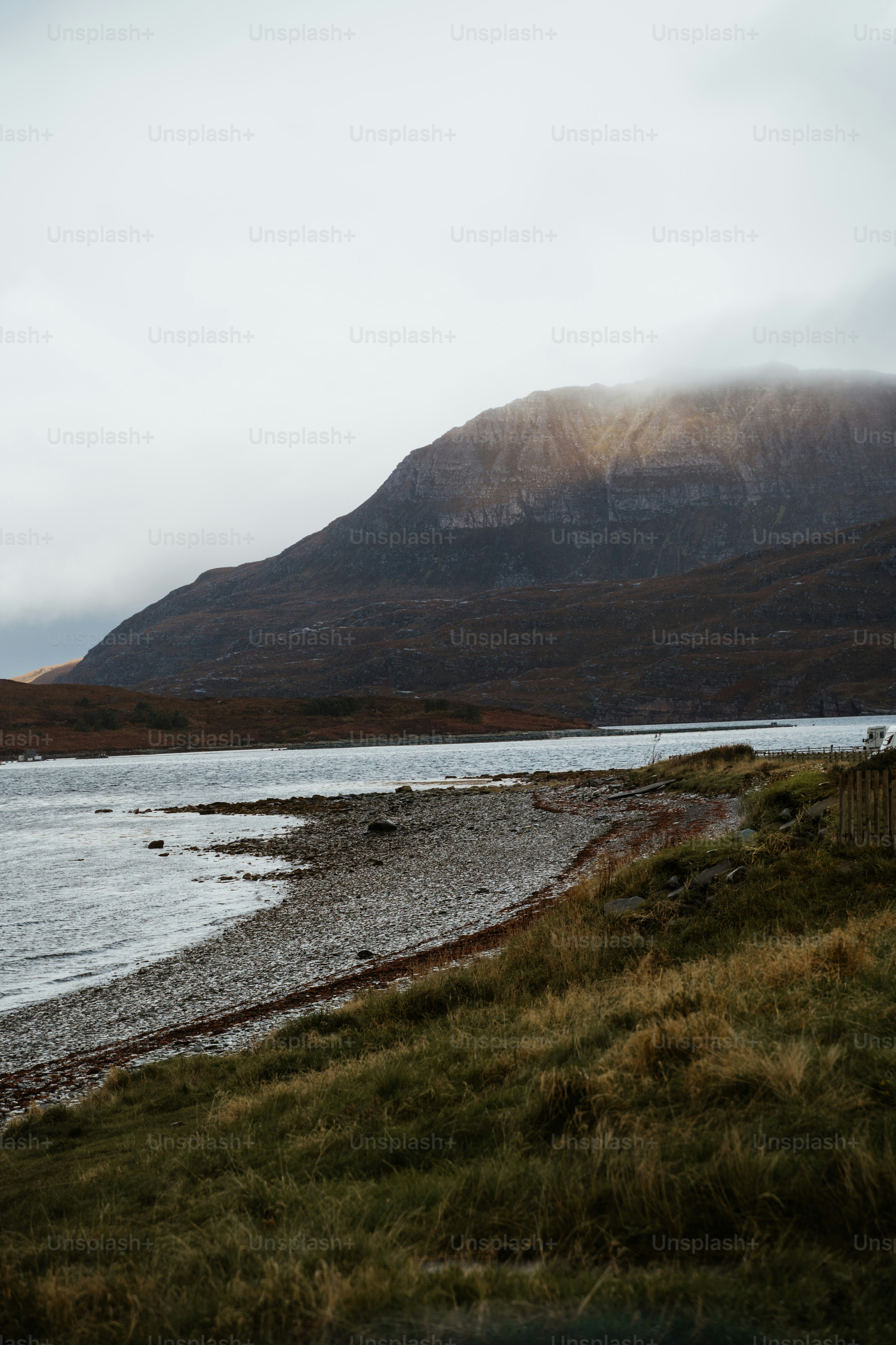 A body of water with a mountain in the background