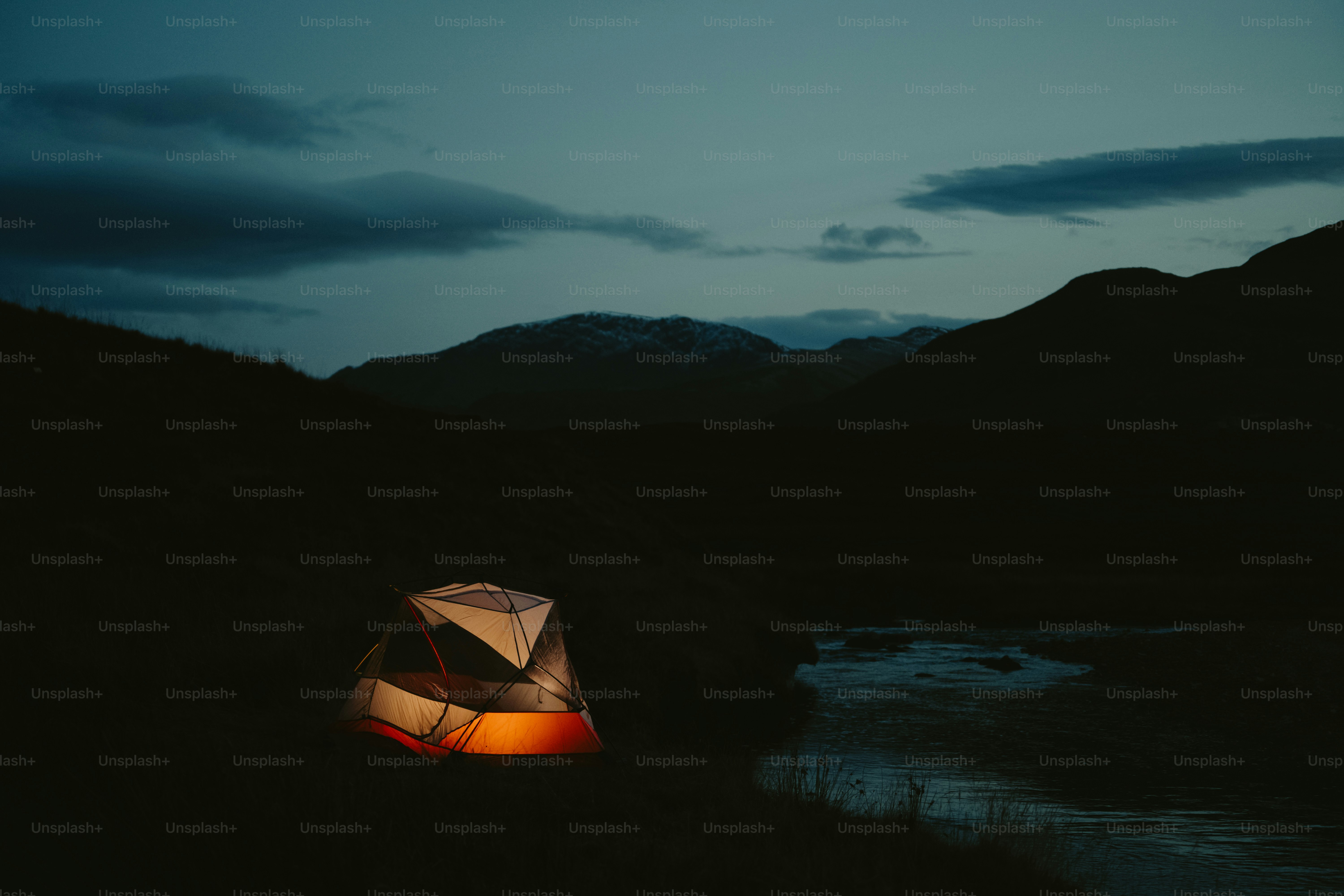 A tent is lit up in the dark