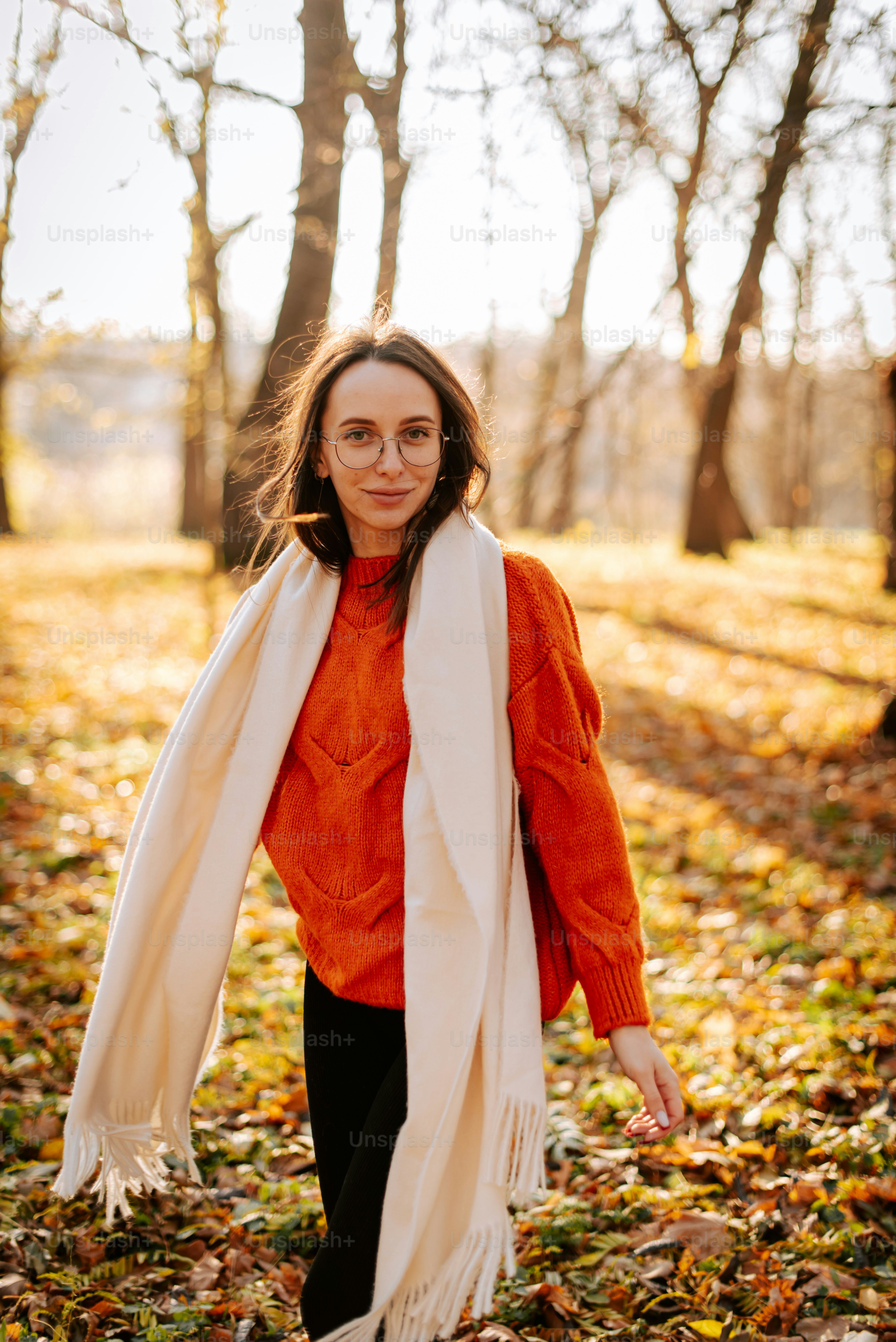 A woman in an orange shirt and white scarf