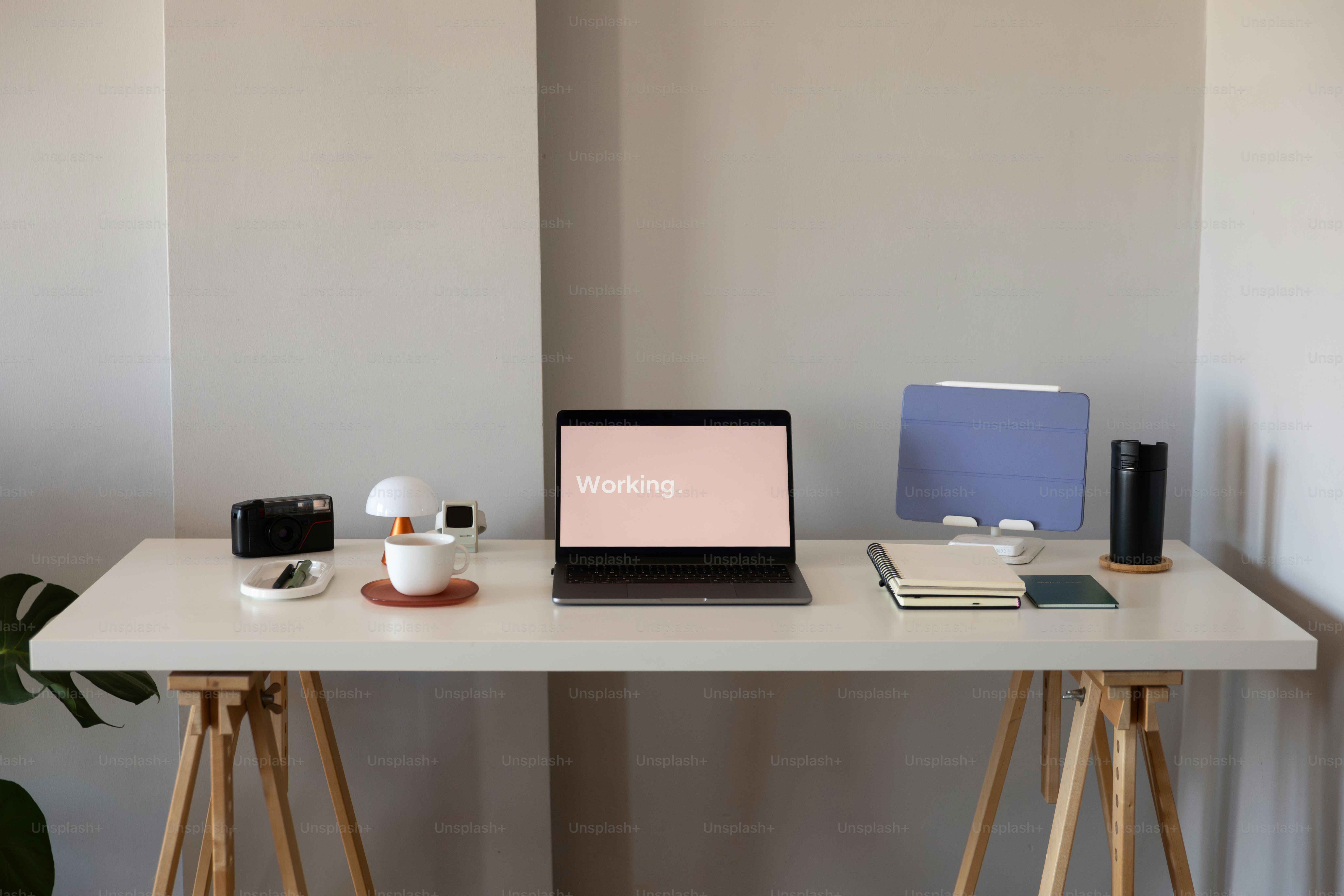 A laptop computer sitting on top of a white desk