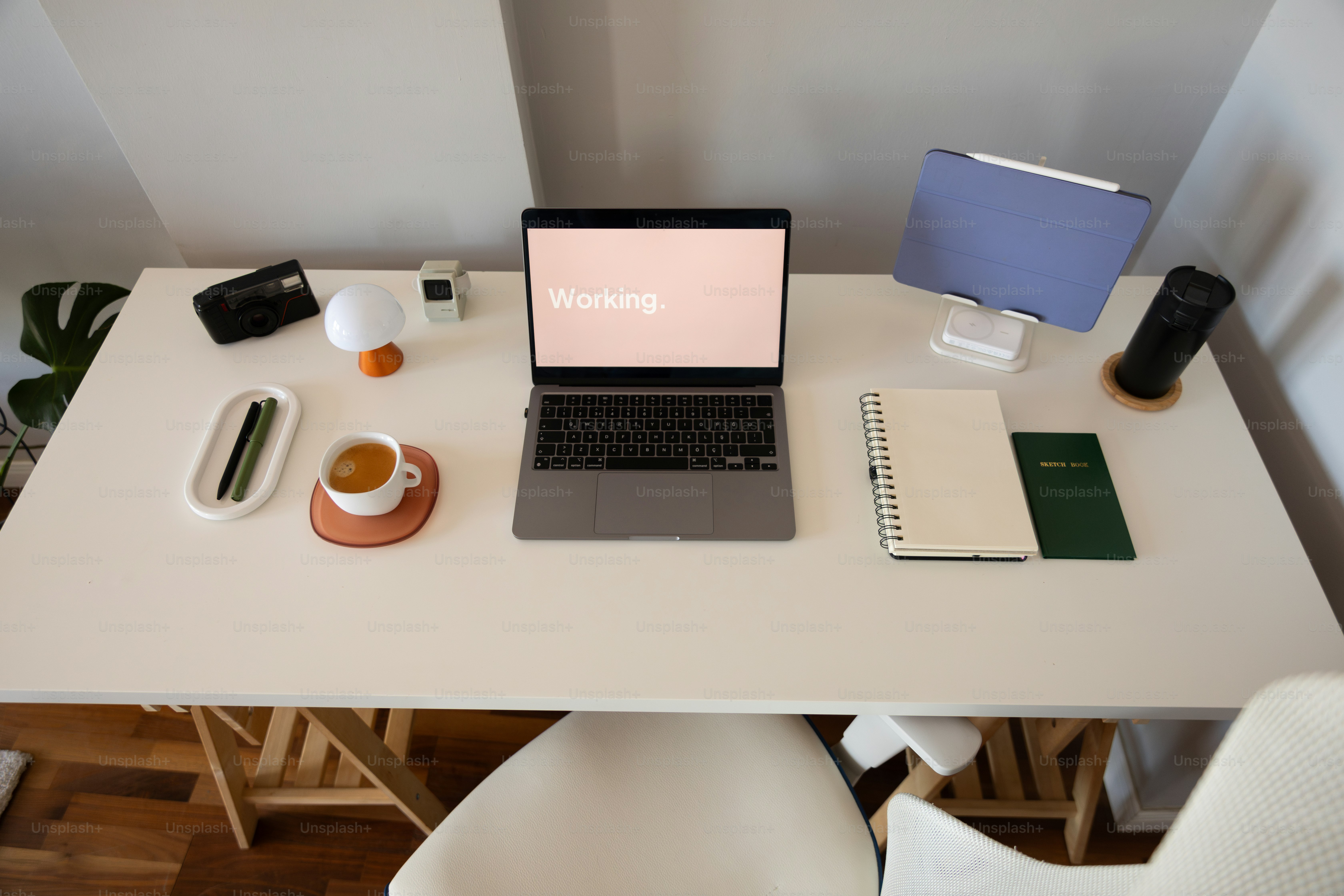 A laptop computer sitting on top of a white desk