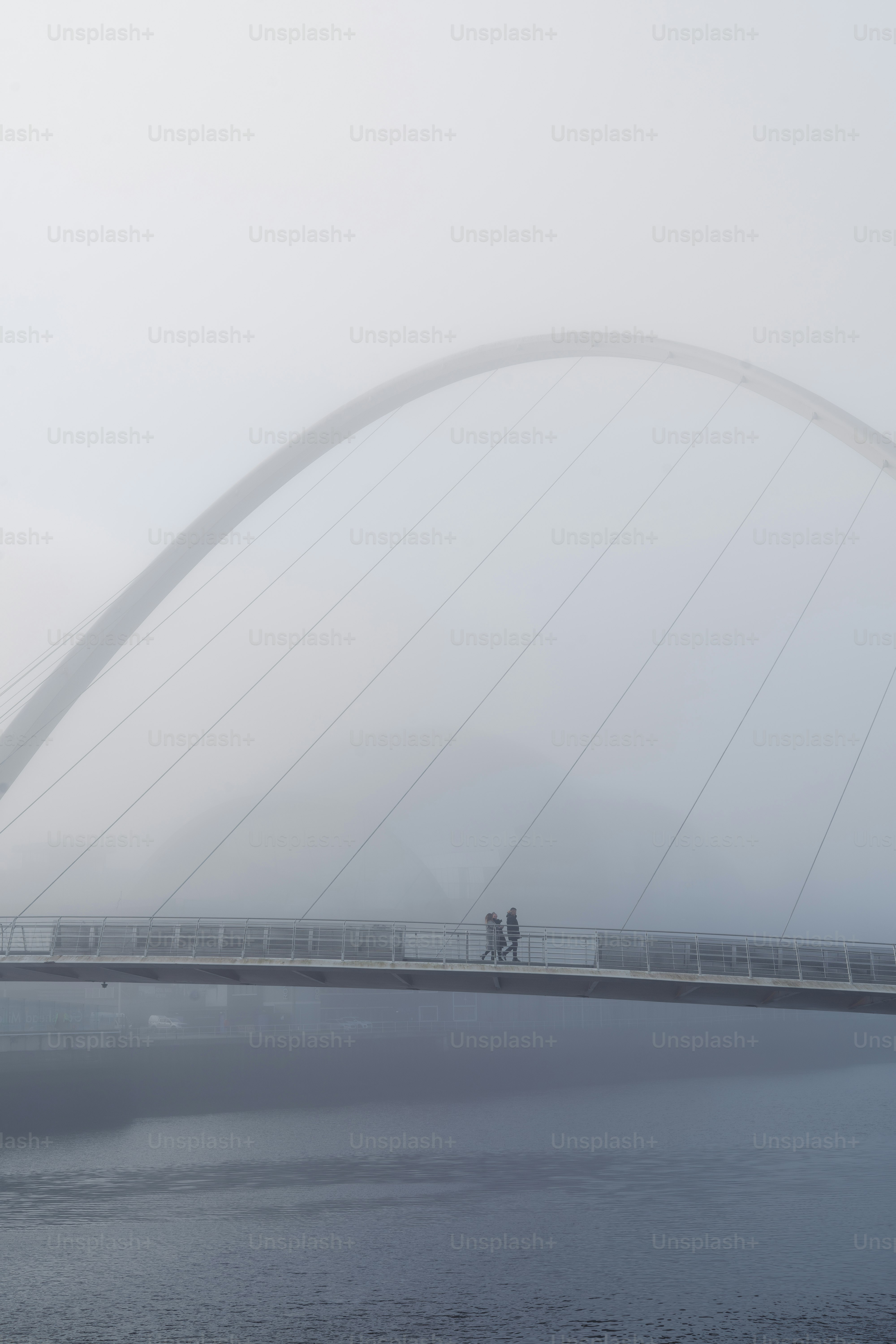 A foggy bridge over a body of water photo – Fog Image on Unsplash