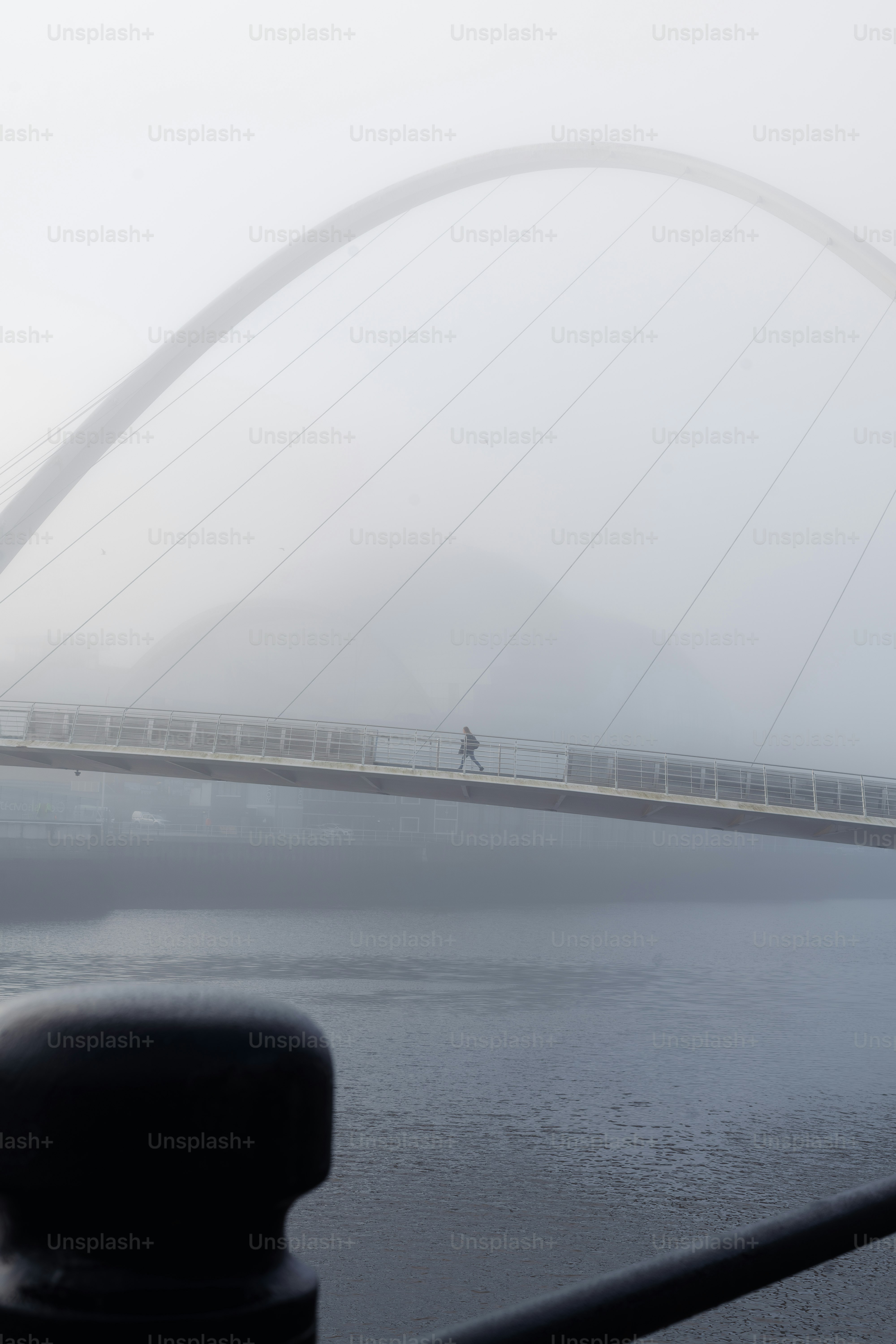 A foggy bridge over a body of water photo – Fog Image on Unsplash