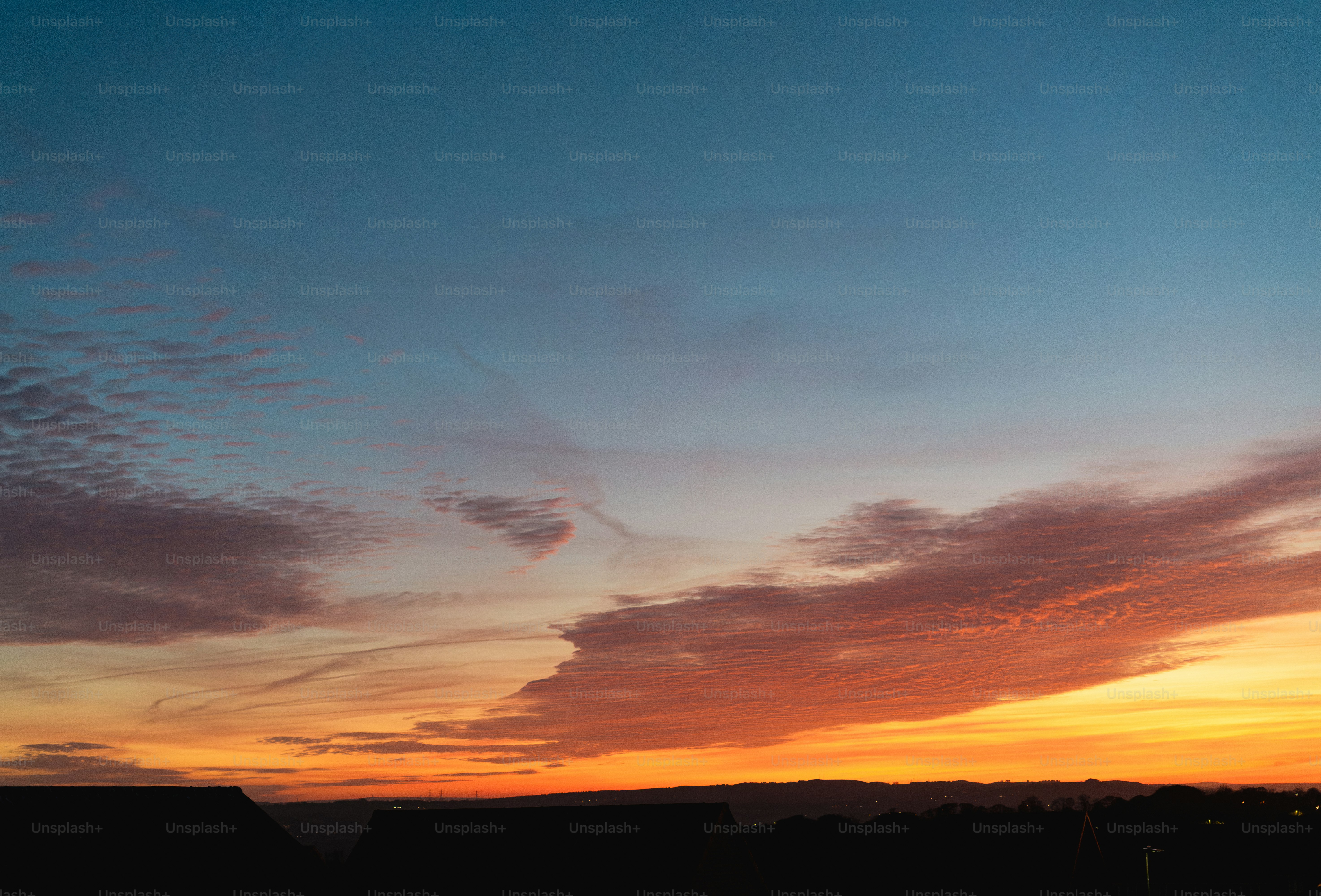 The sun is setting over the horizon of a field