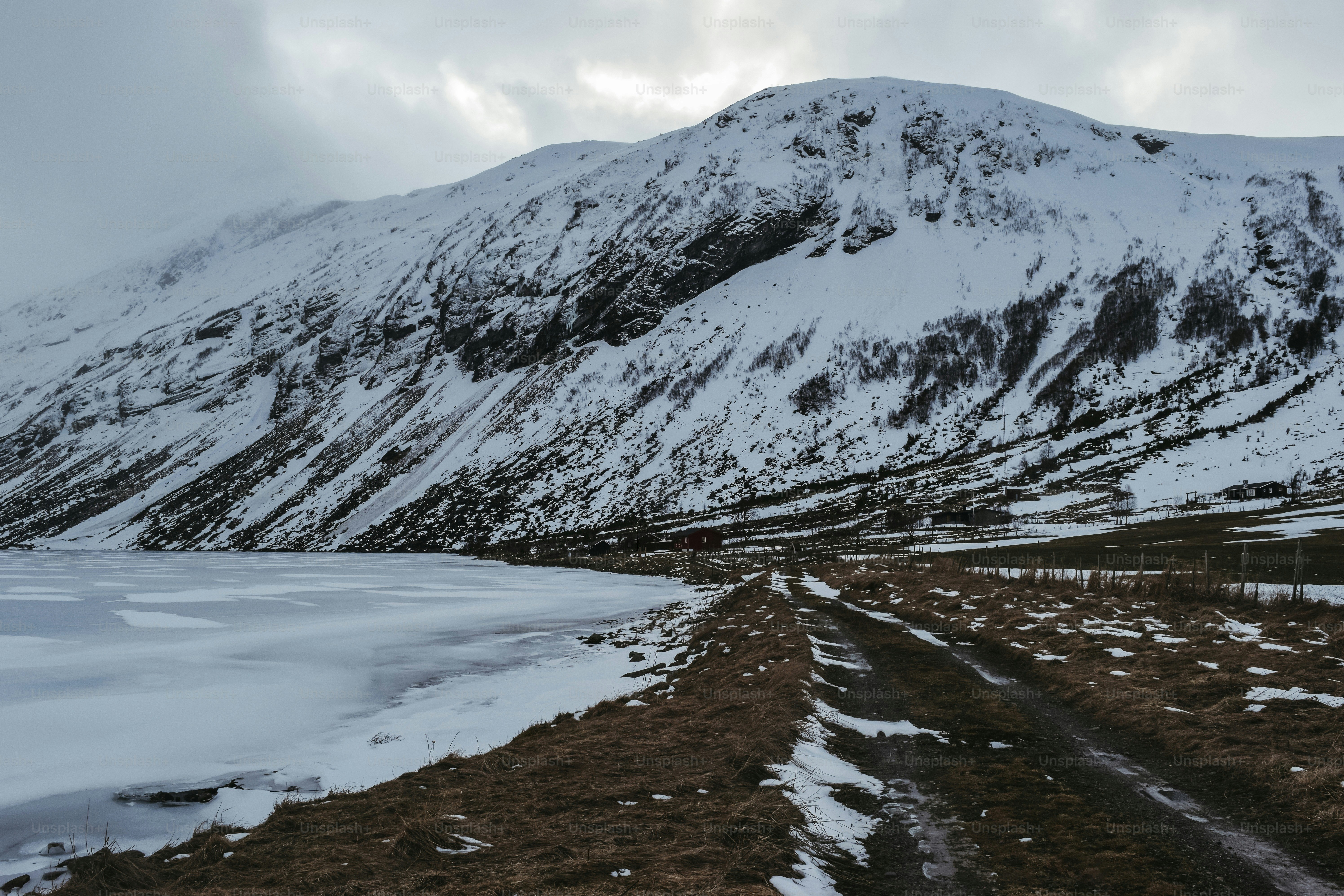 A snow covered mountain with a road in the foreground