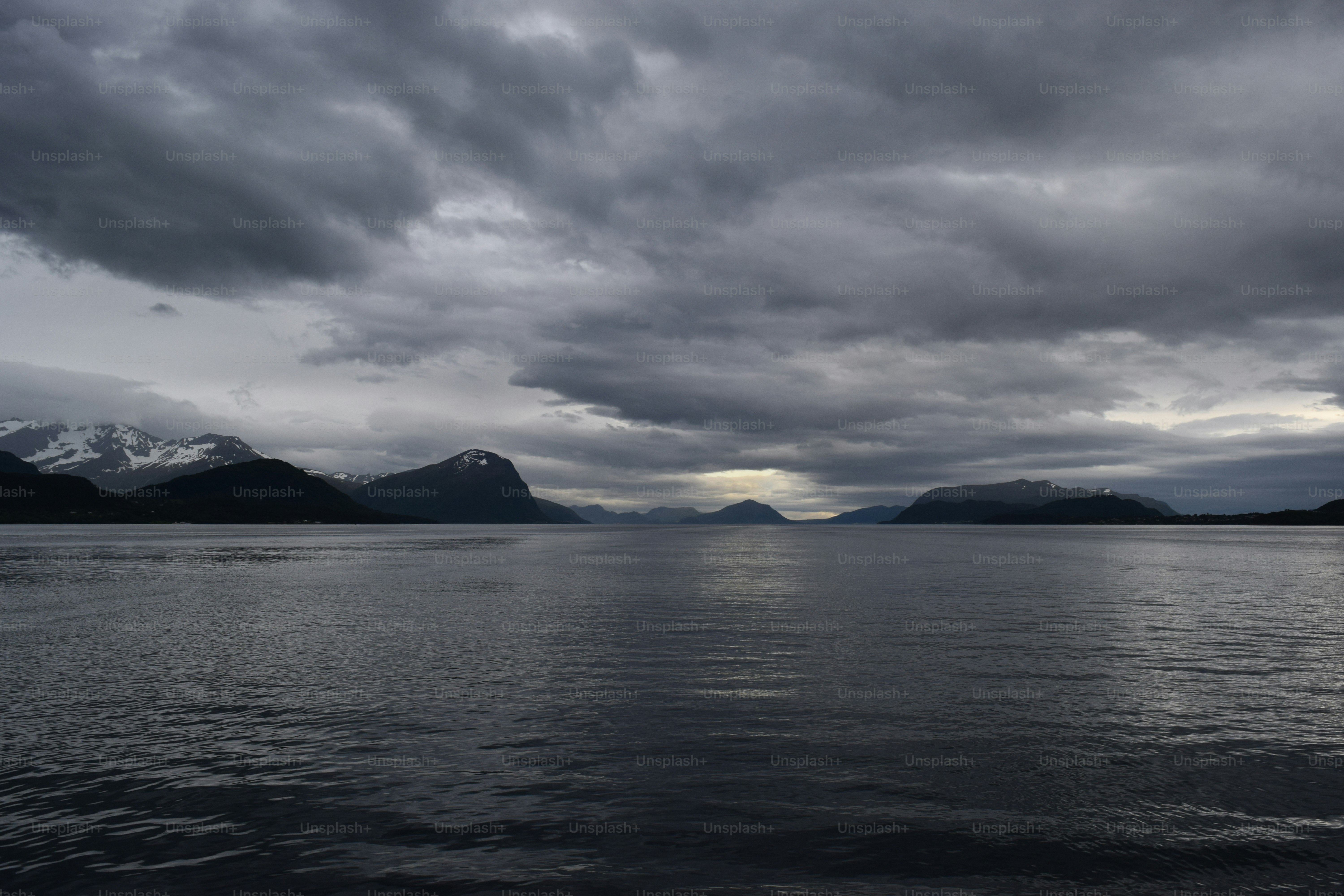 A large body of water under a cloudy sky
