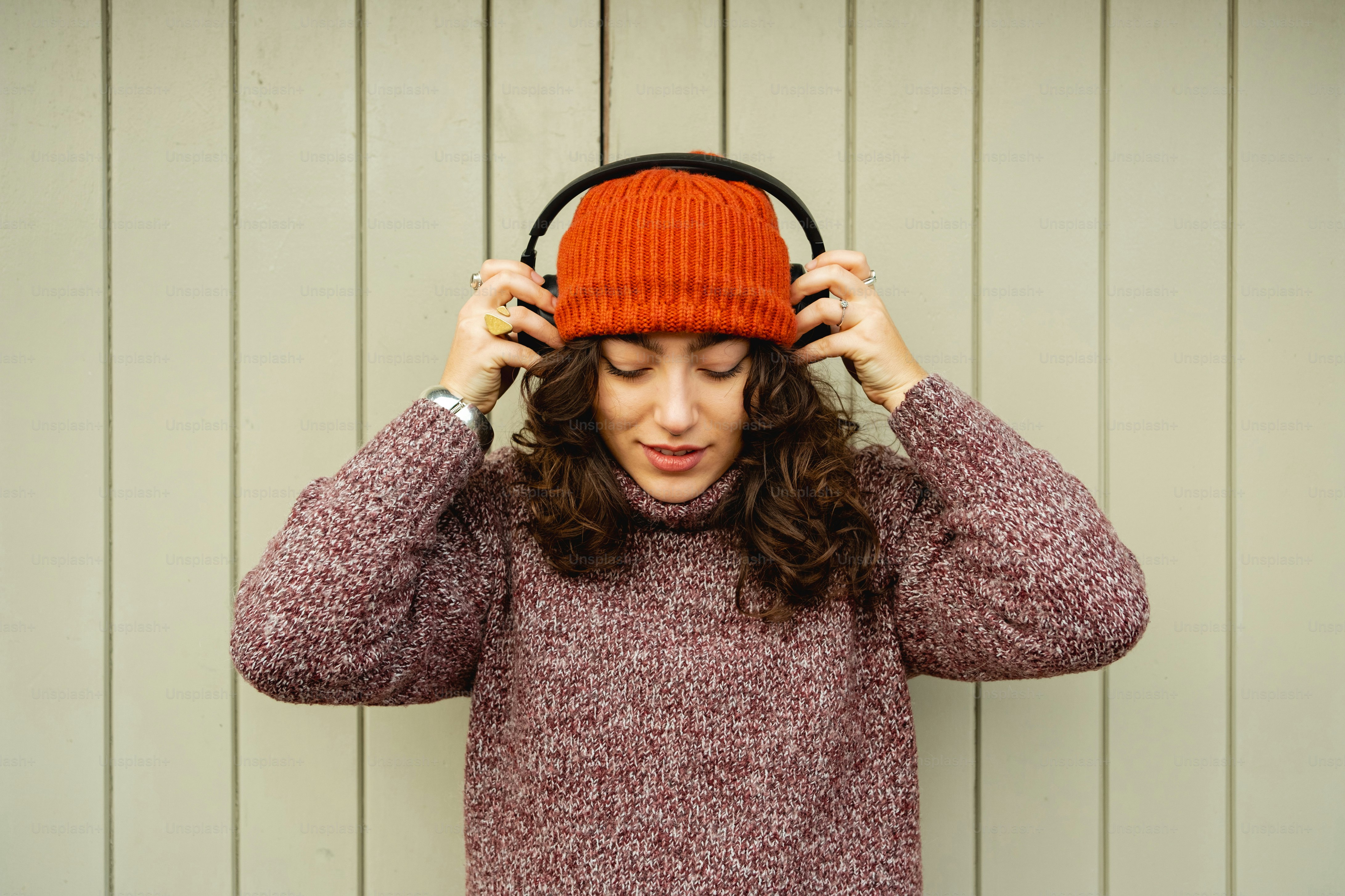 A woman wearing a red hat and a purple sweater