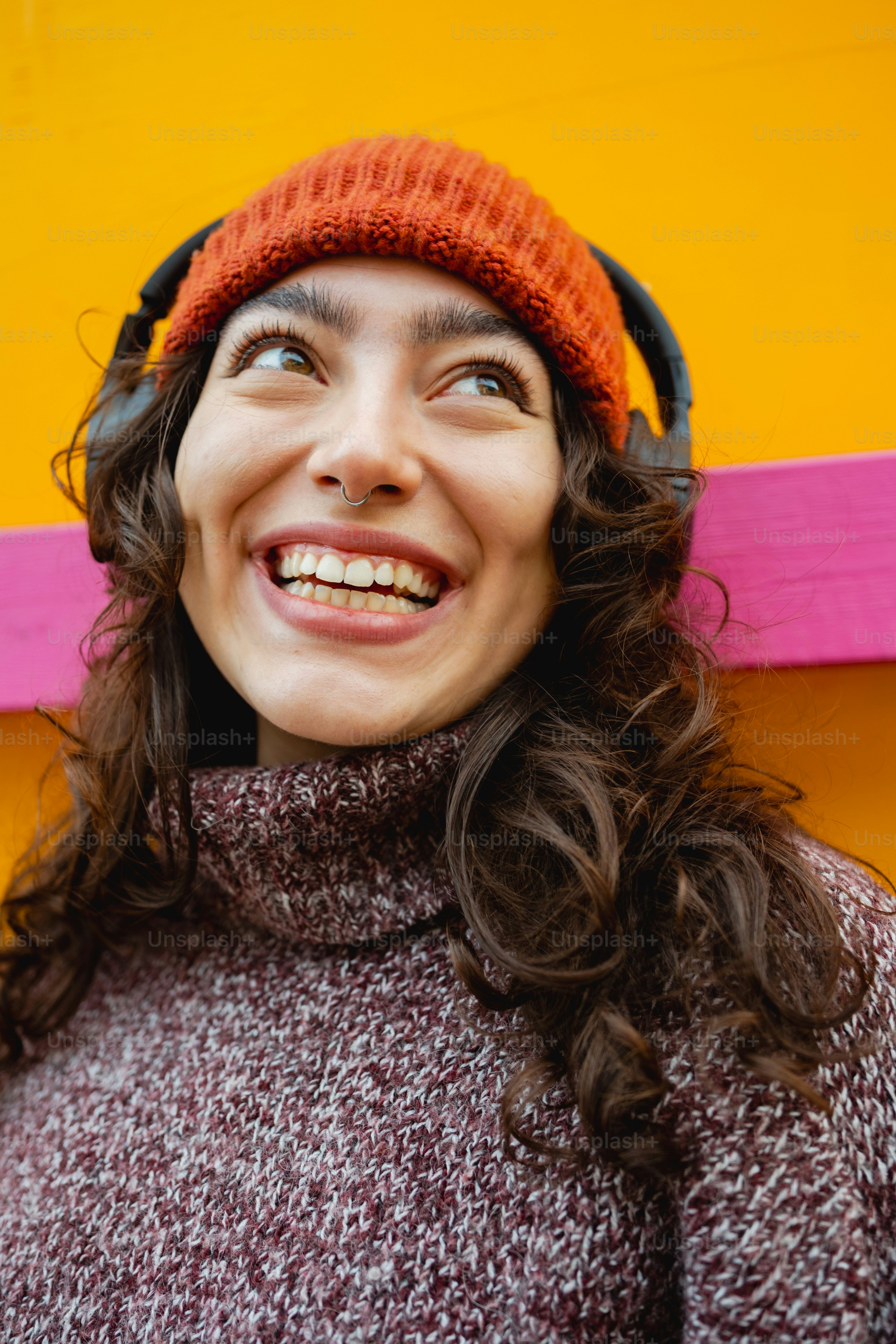 A woman wearing headphones and a sweater