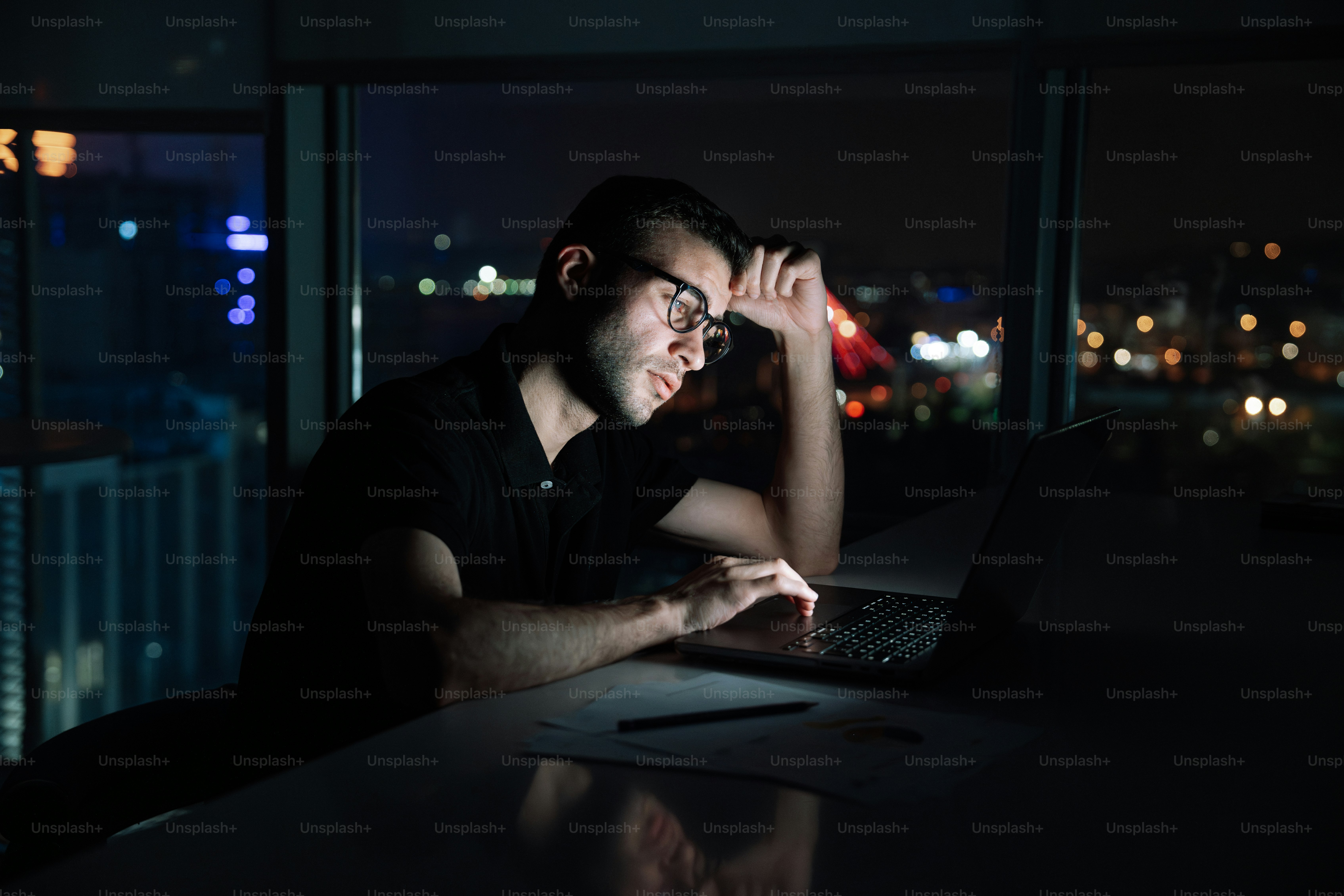 A man sitting in front of a laptop computer