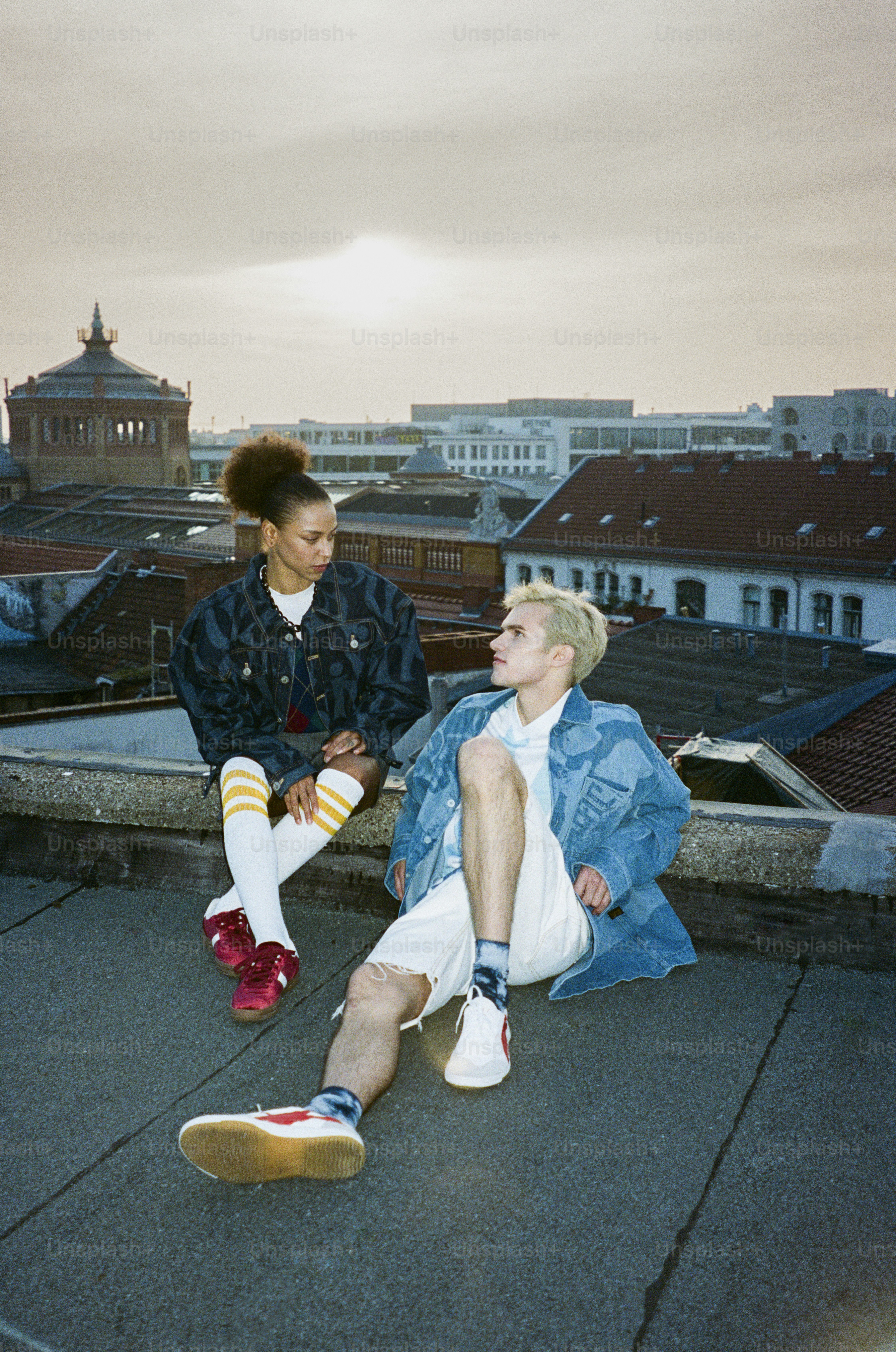 A couple of people sitting on top of a roof