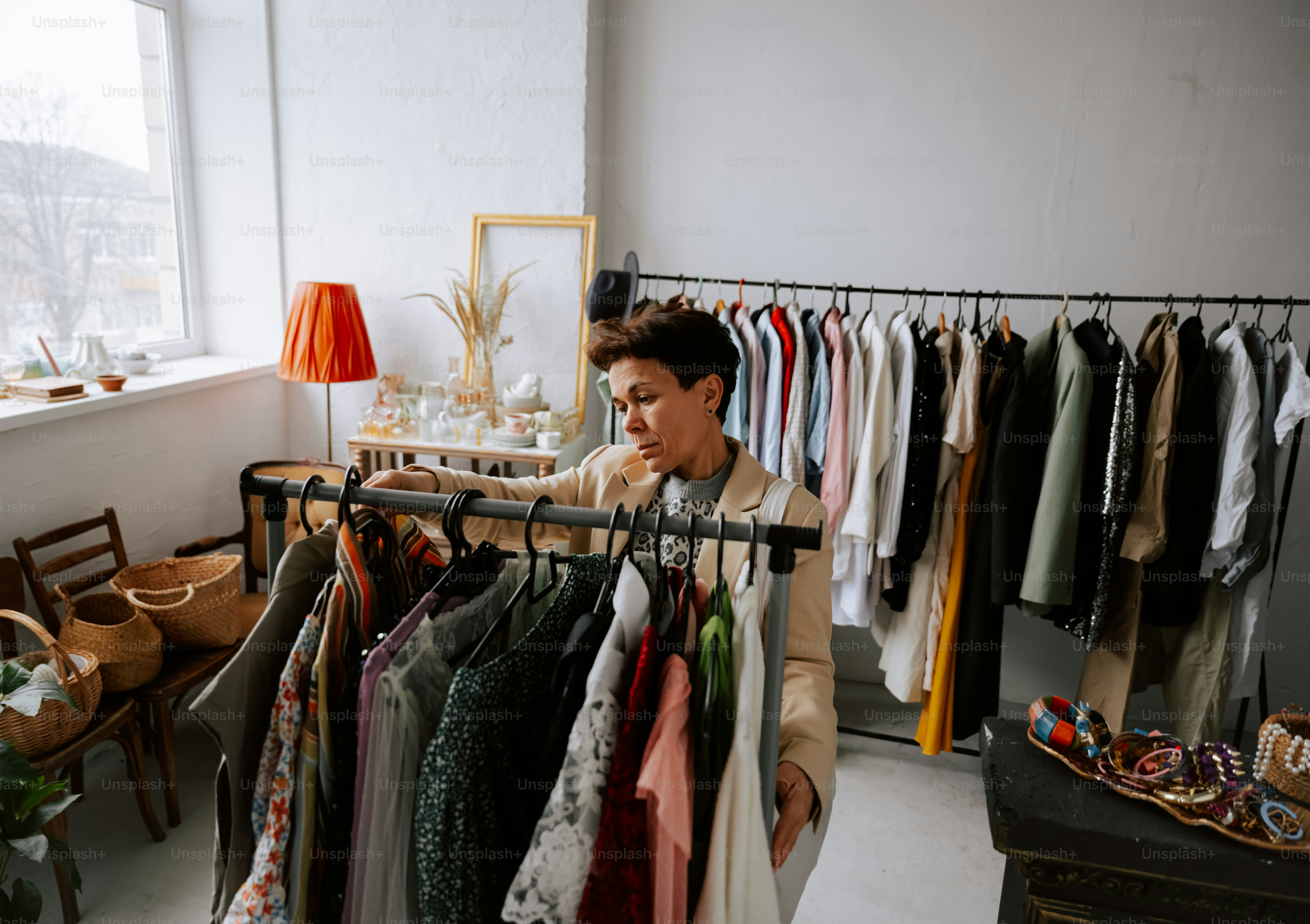 A woman looking at a rack of clothes photo – Pre loved Image on Unsplash