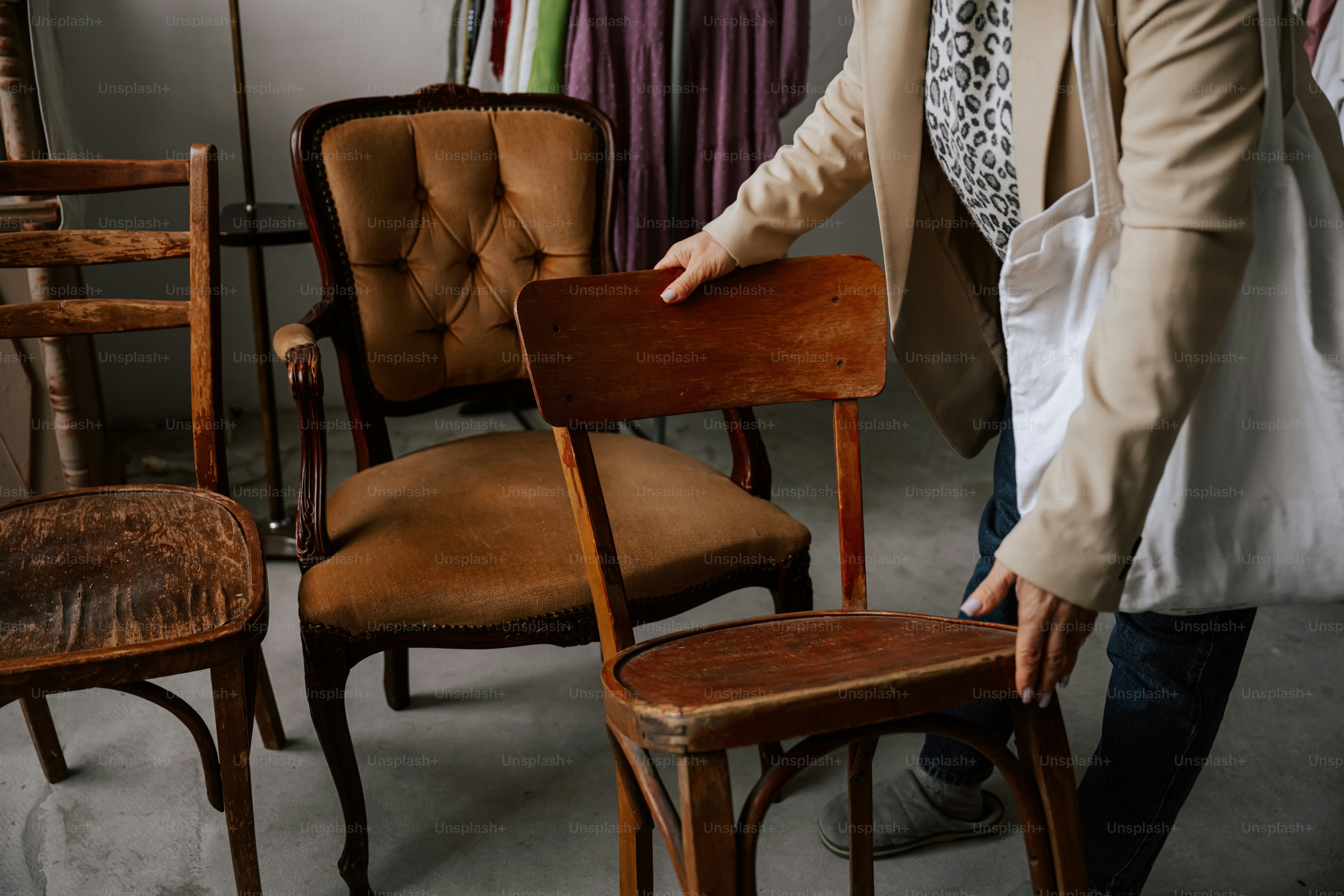 A woman standing next to a chair in a room