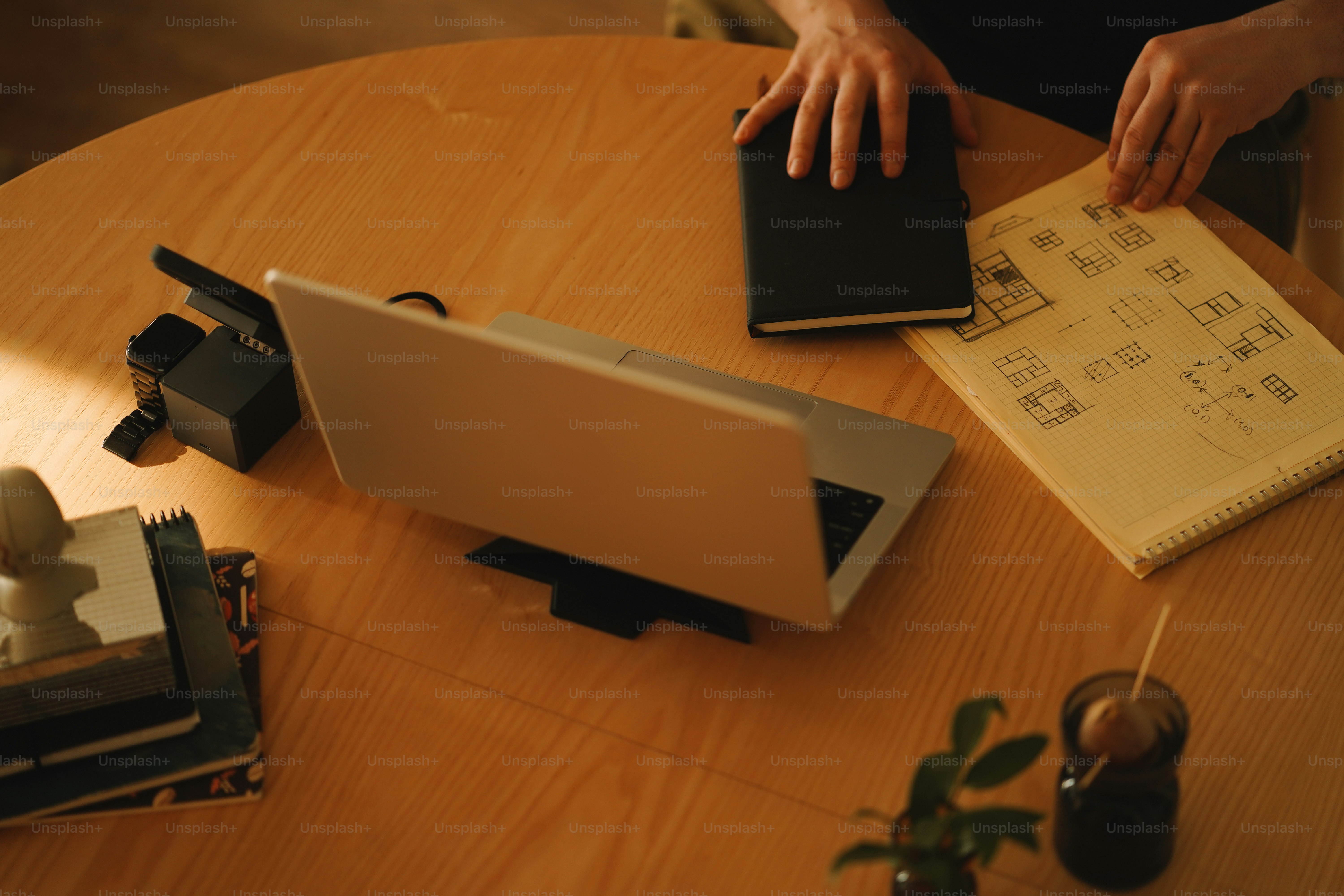 A person sitting at a table using a laptop computer photo – Home office ...