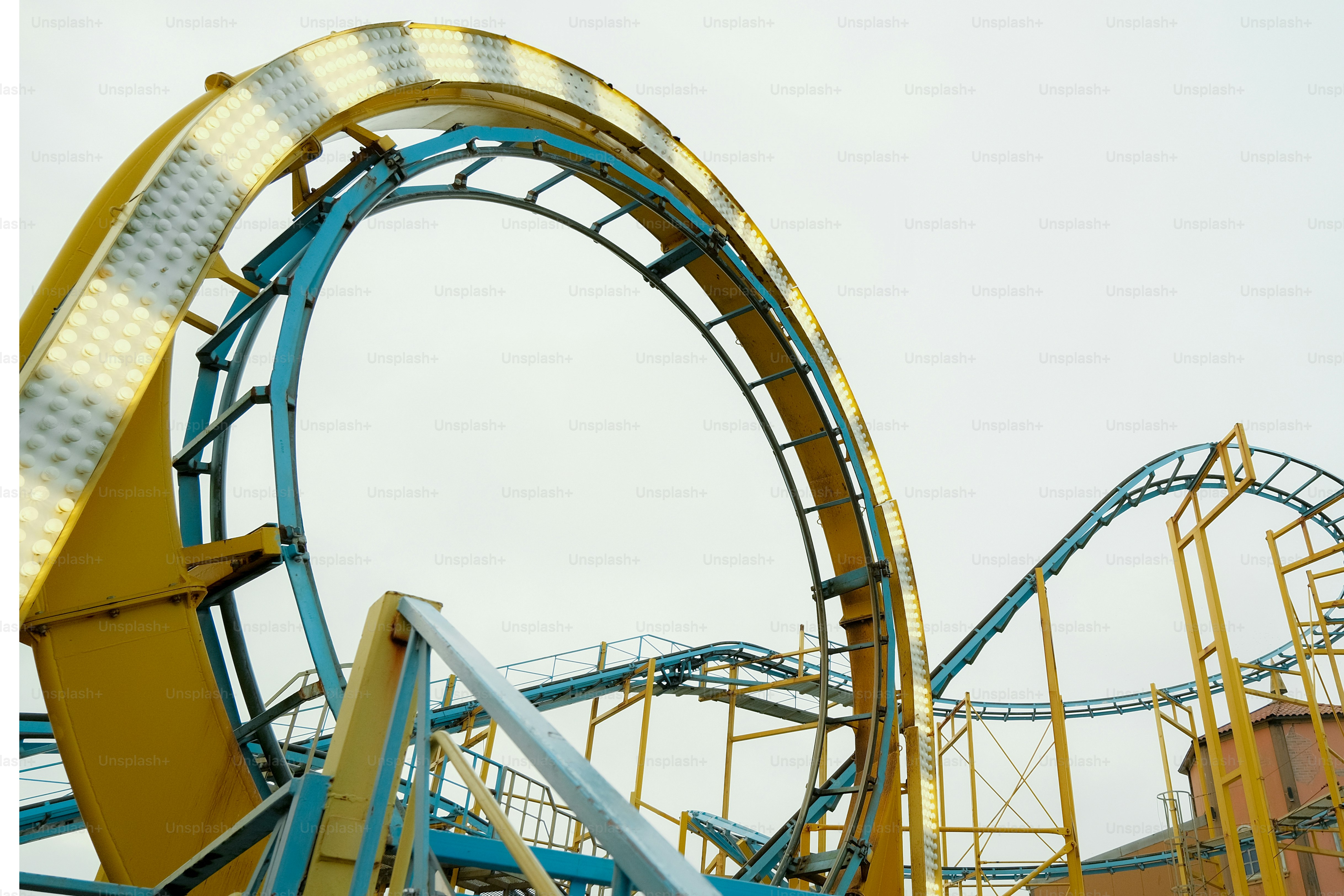 A roller coaster going down a hill on a cloudy day