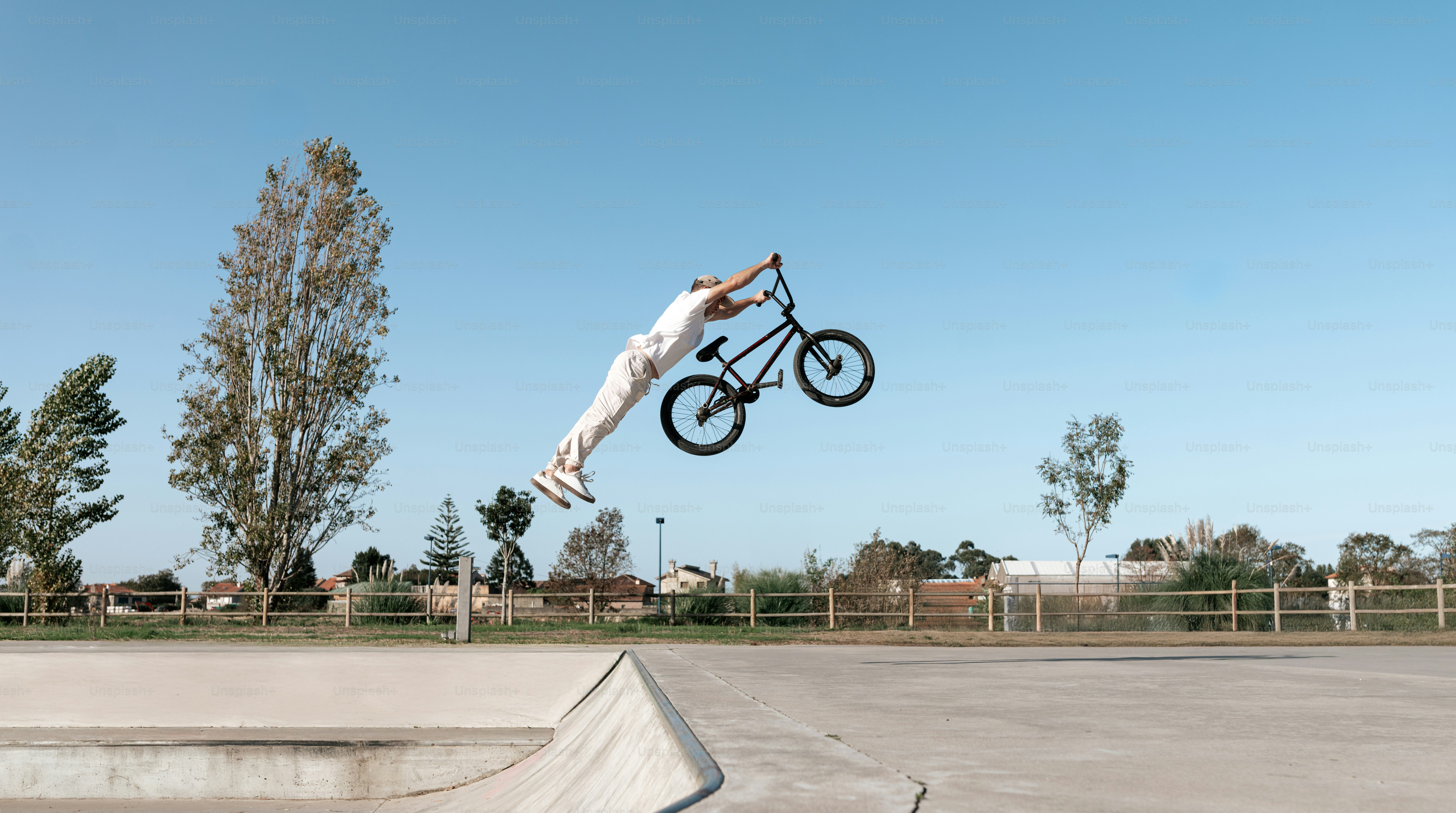 A man flying through the air while riding a bike