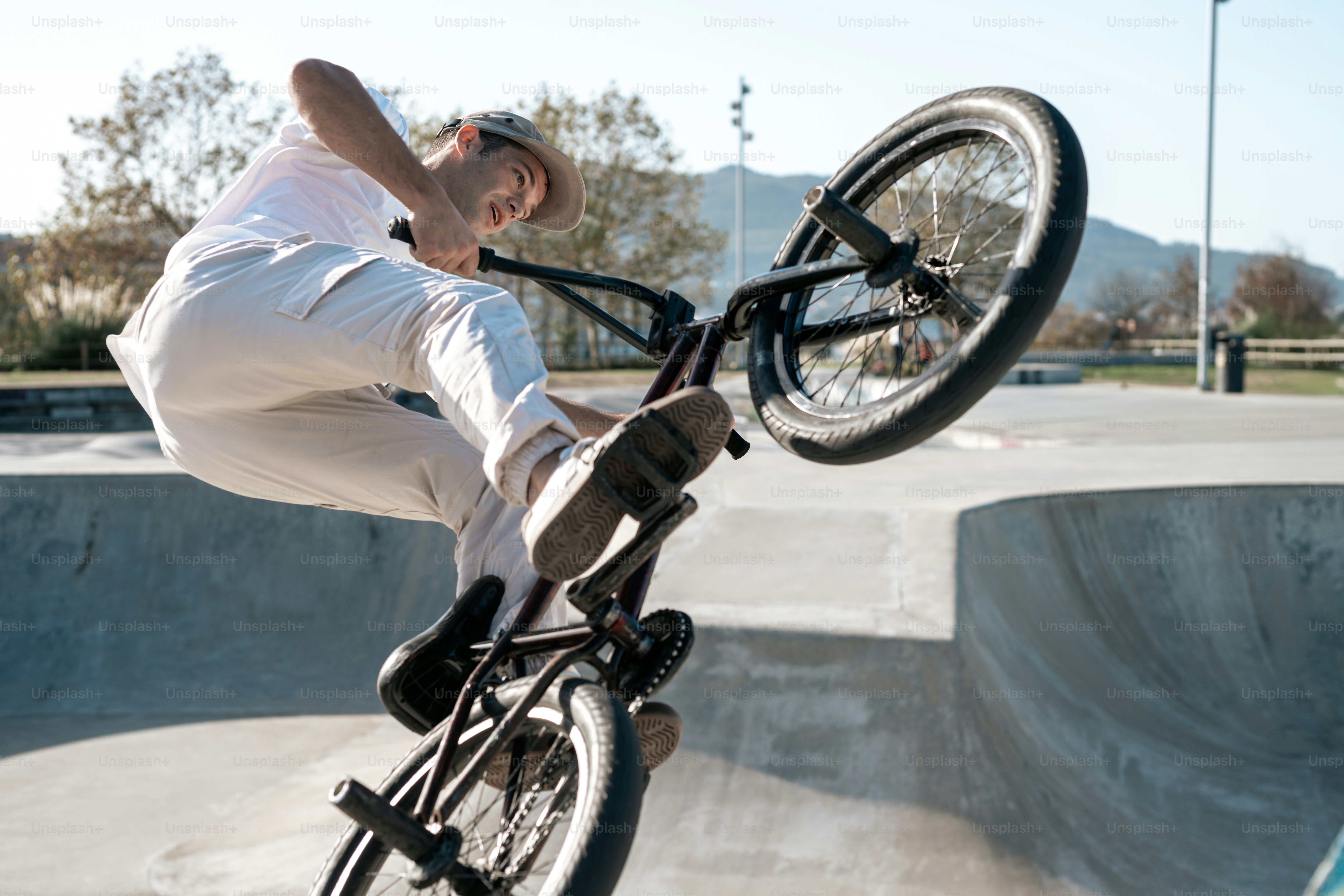 A man riding a bike up the side of a ramp