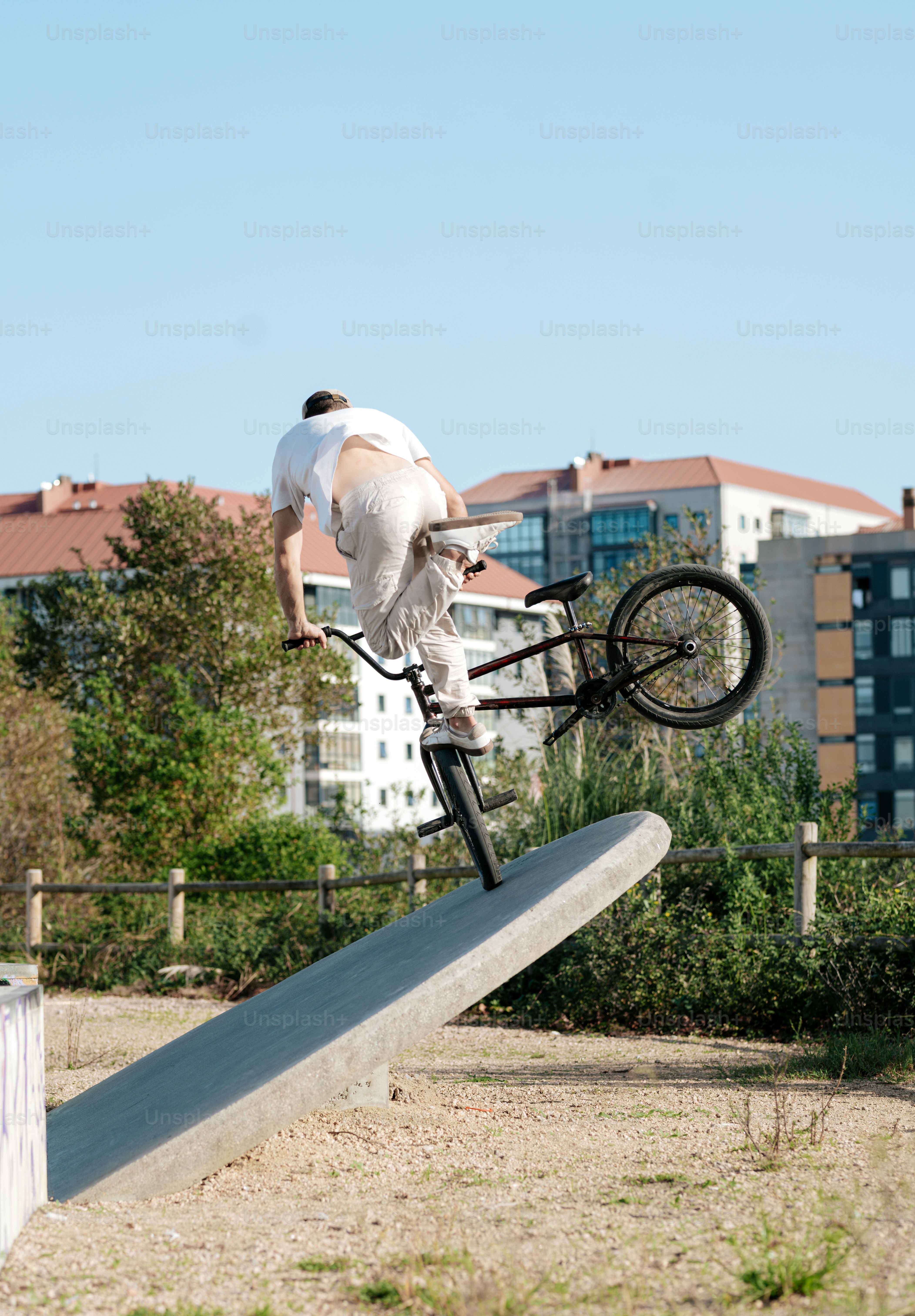A man riding a bike on top of a metal rail