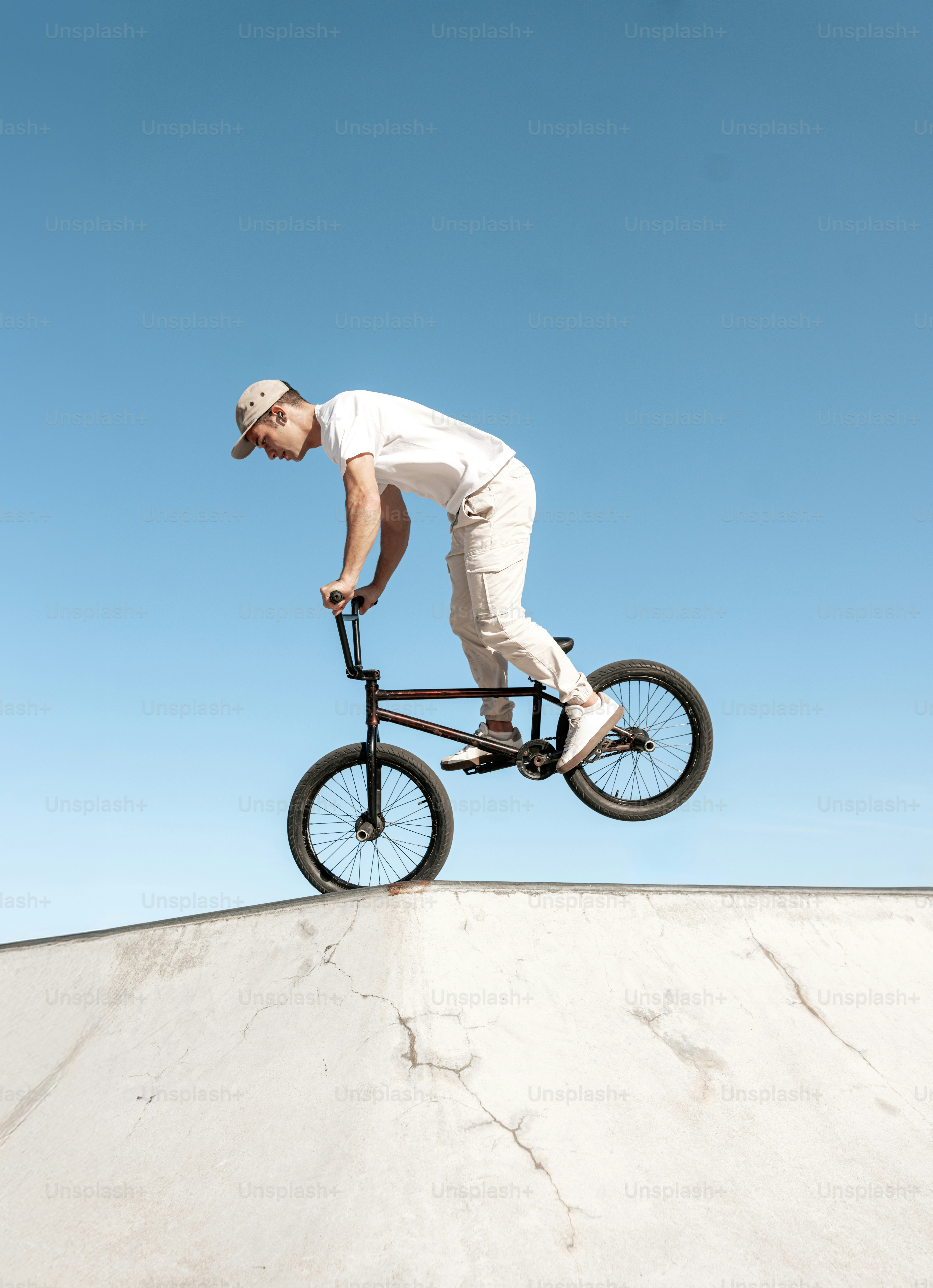 A man riding a bike up the side of a ramp