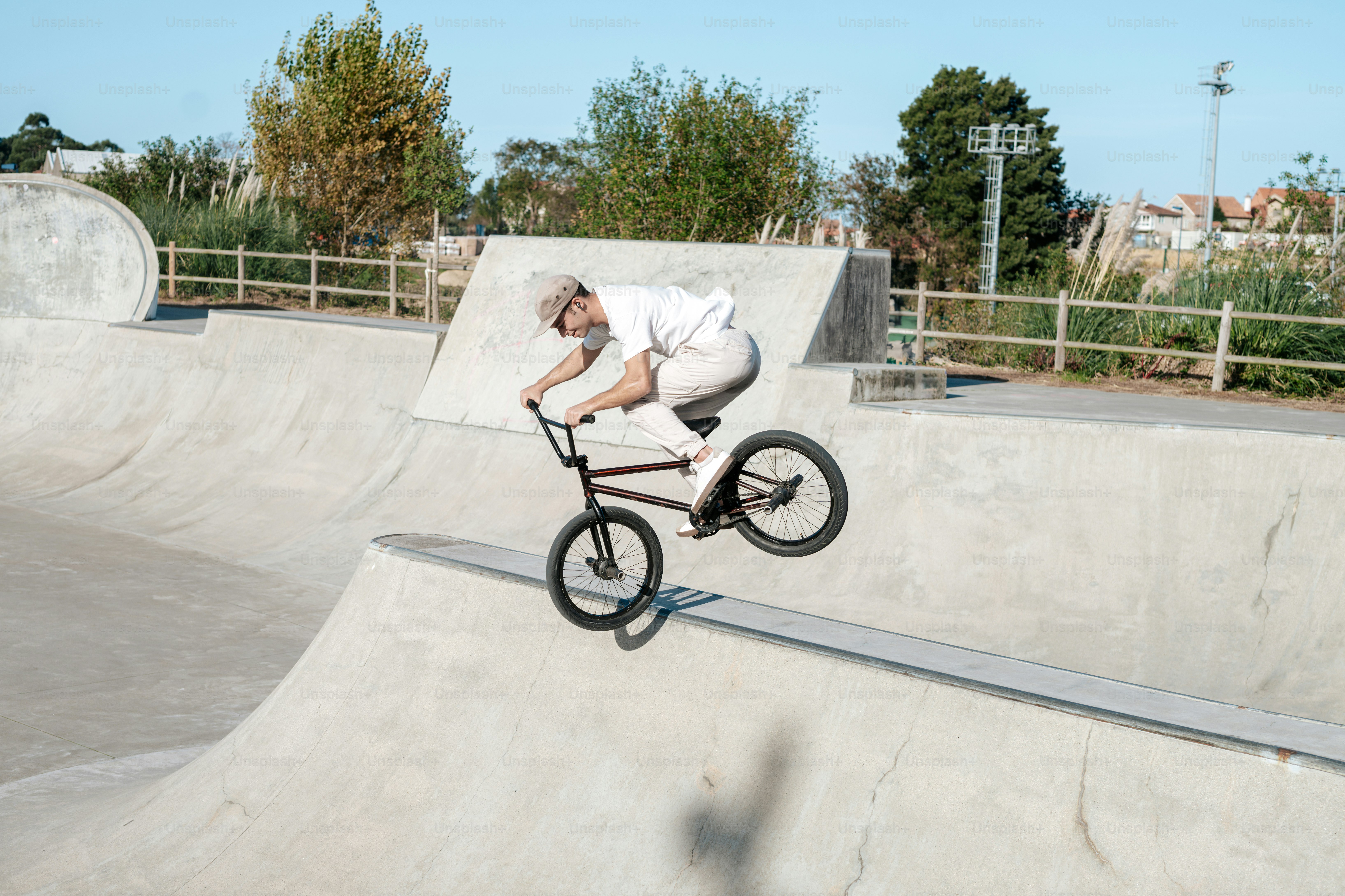A man riding a bike up the side of a ramp