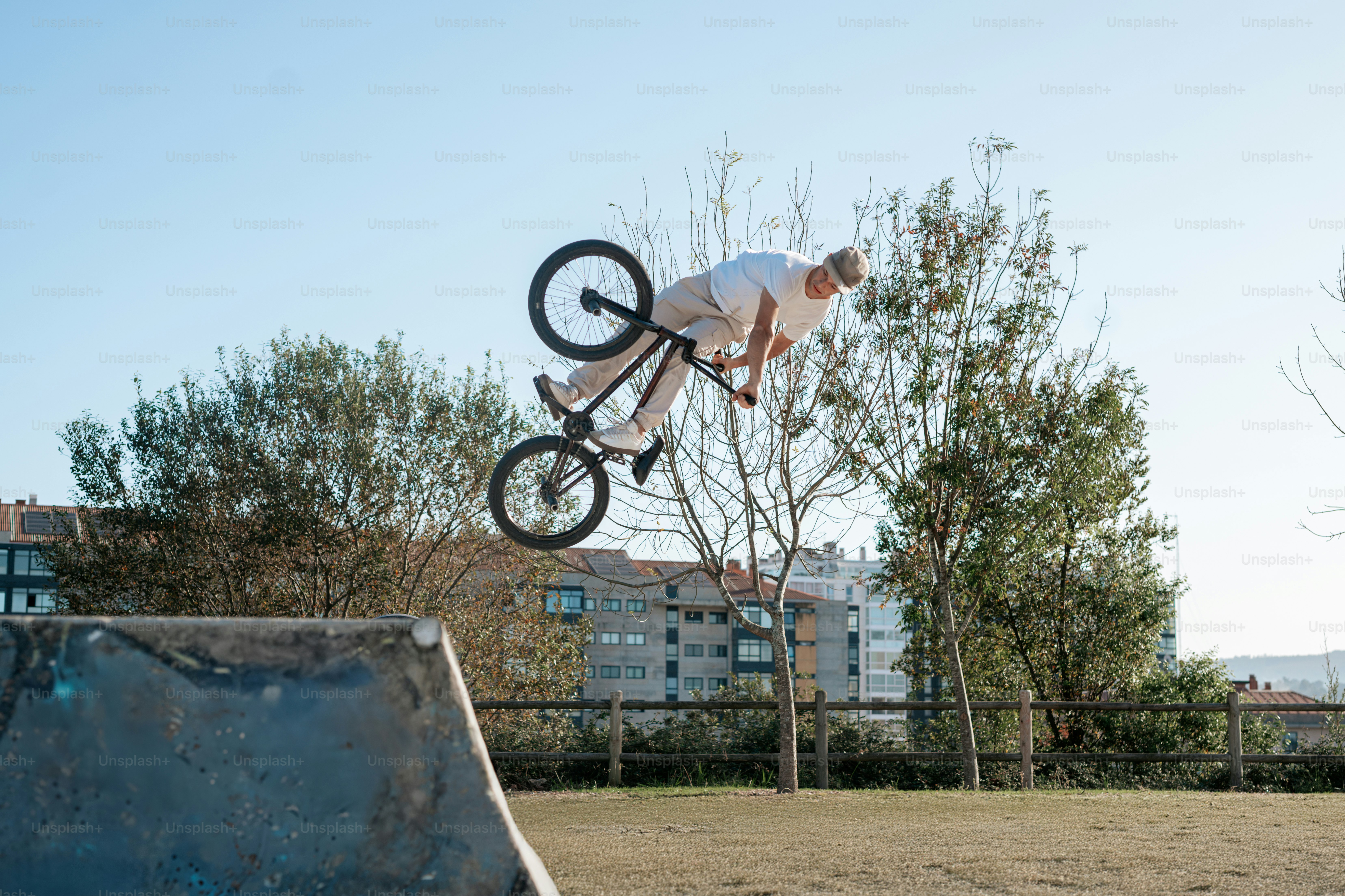 A man flying through the air while riding a bike