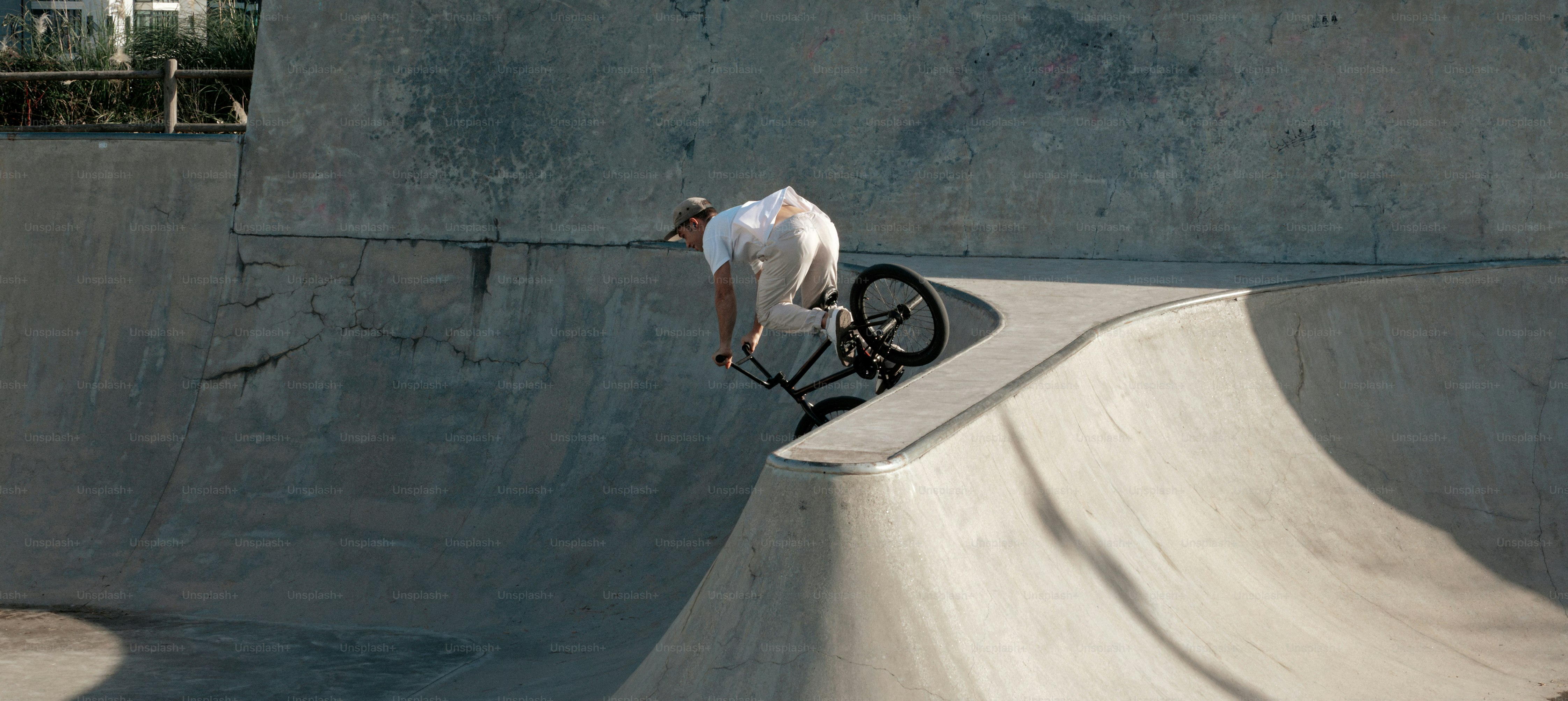 A man riding a skateboard up the side of a ramp