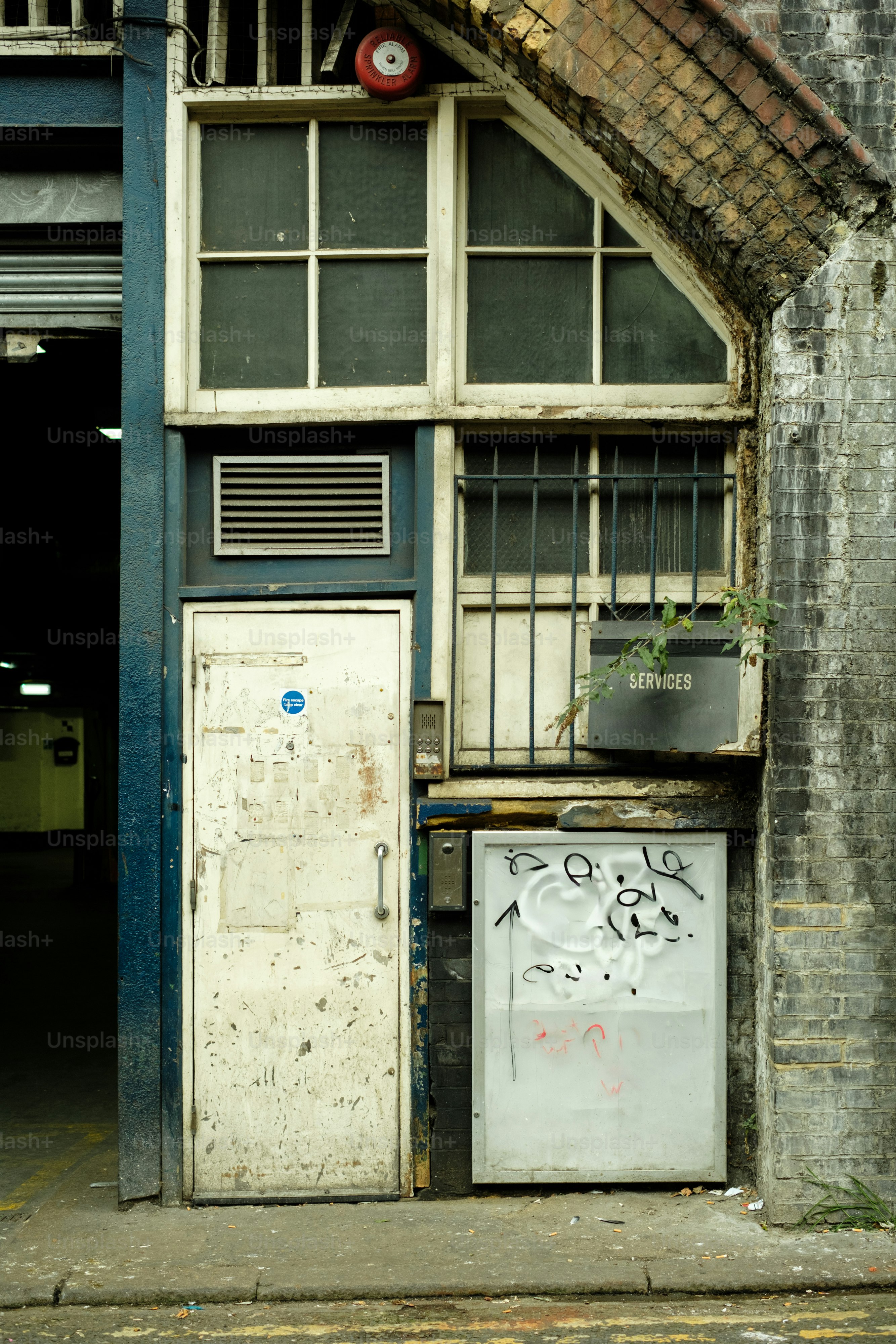 An old building with graffiti on the side of it