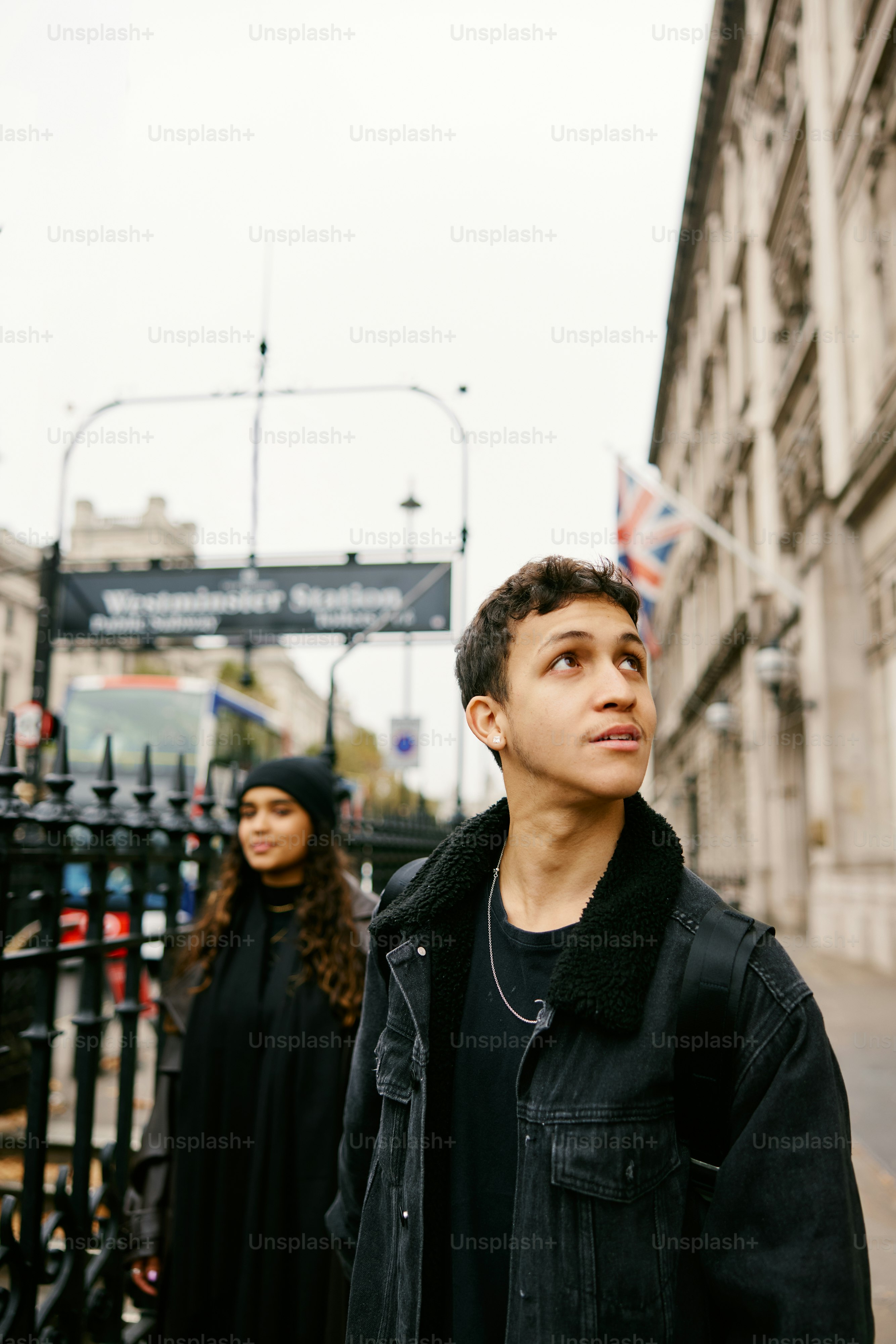 A man standing next to a woman on a sidewalk