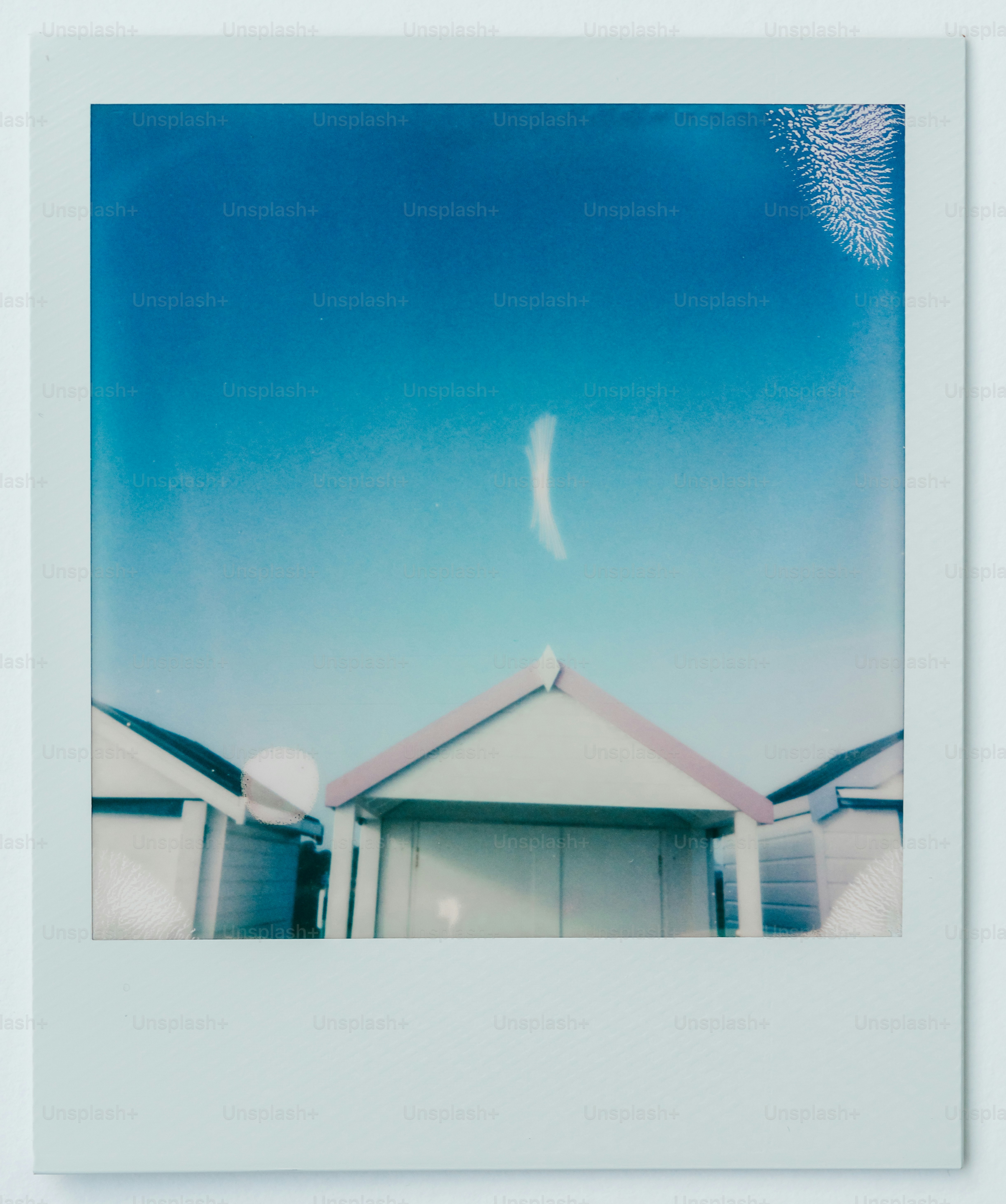 A polaroid photo of a beach hut