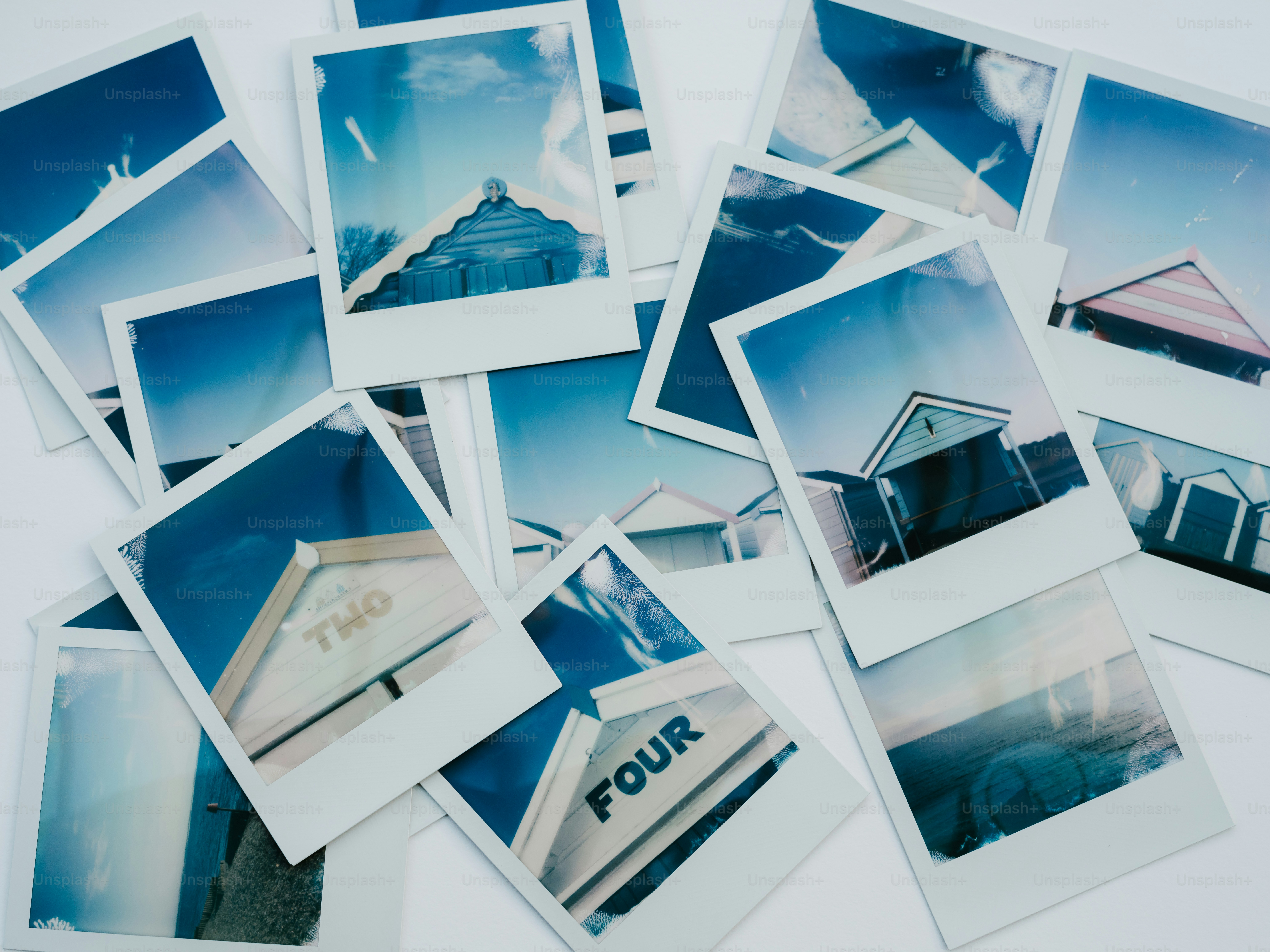 A pile of polaroid pictures of houses and buildings