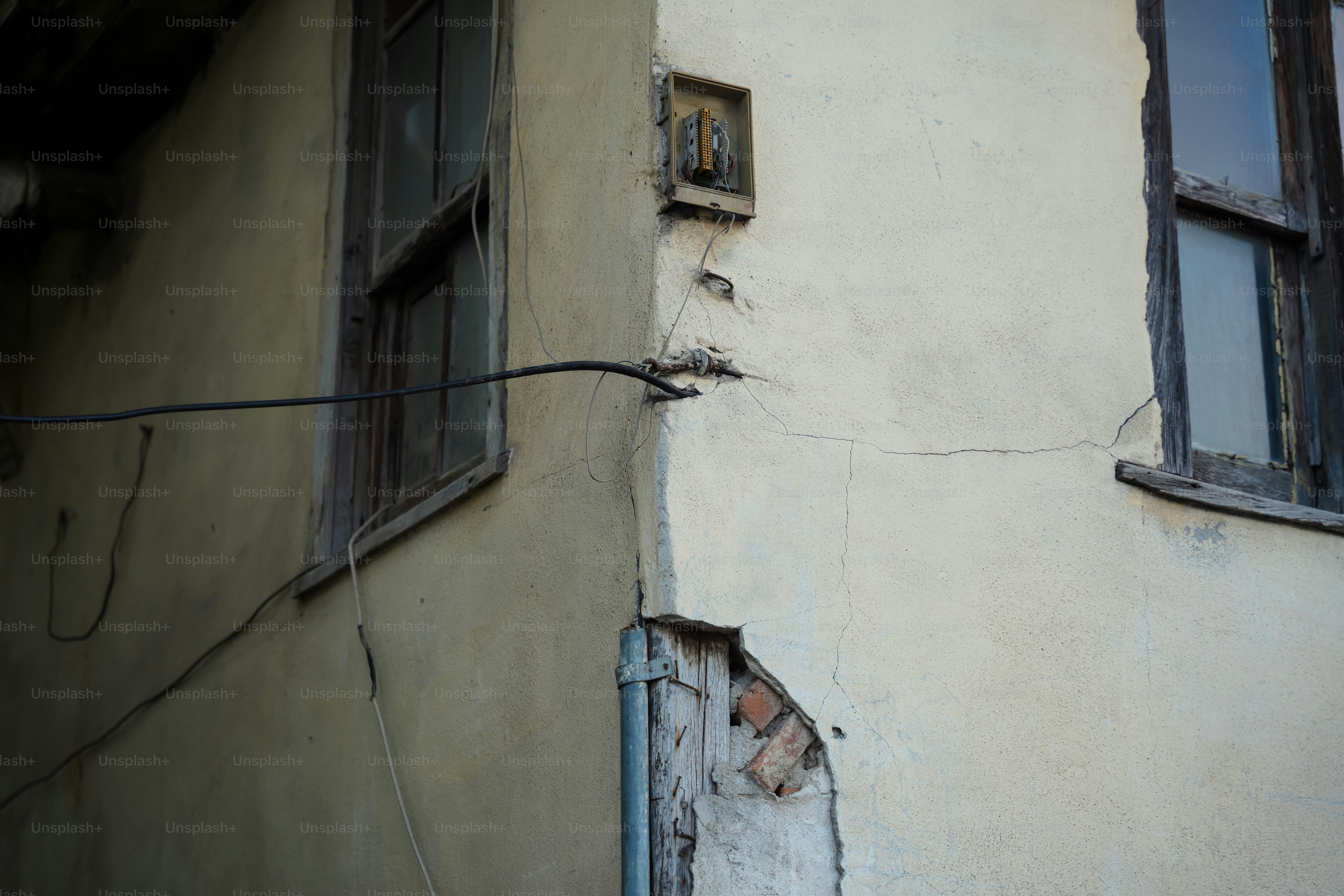 A building with a broken window next to a power line