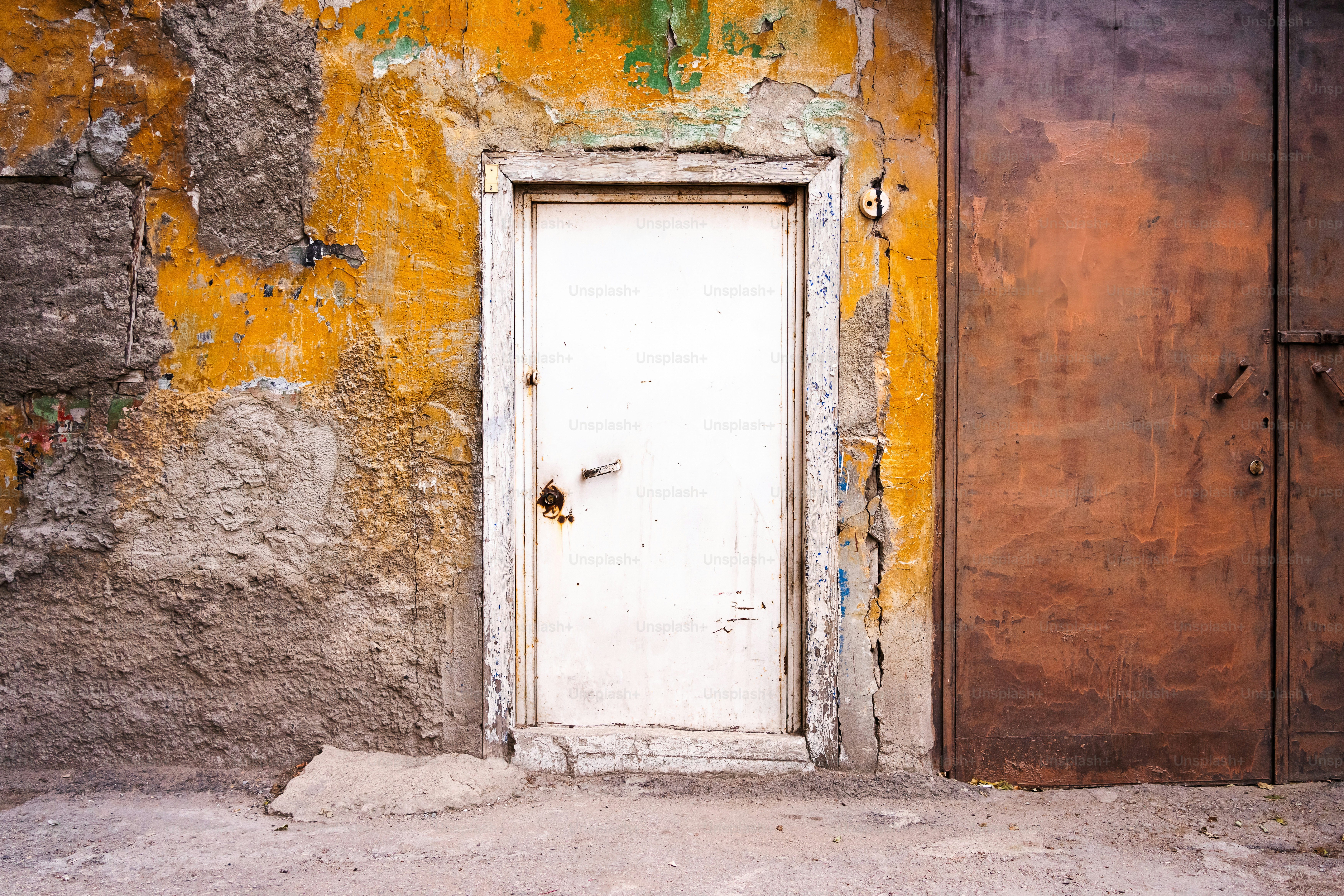 A white door sitting in front of a yellow wall