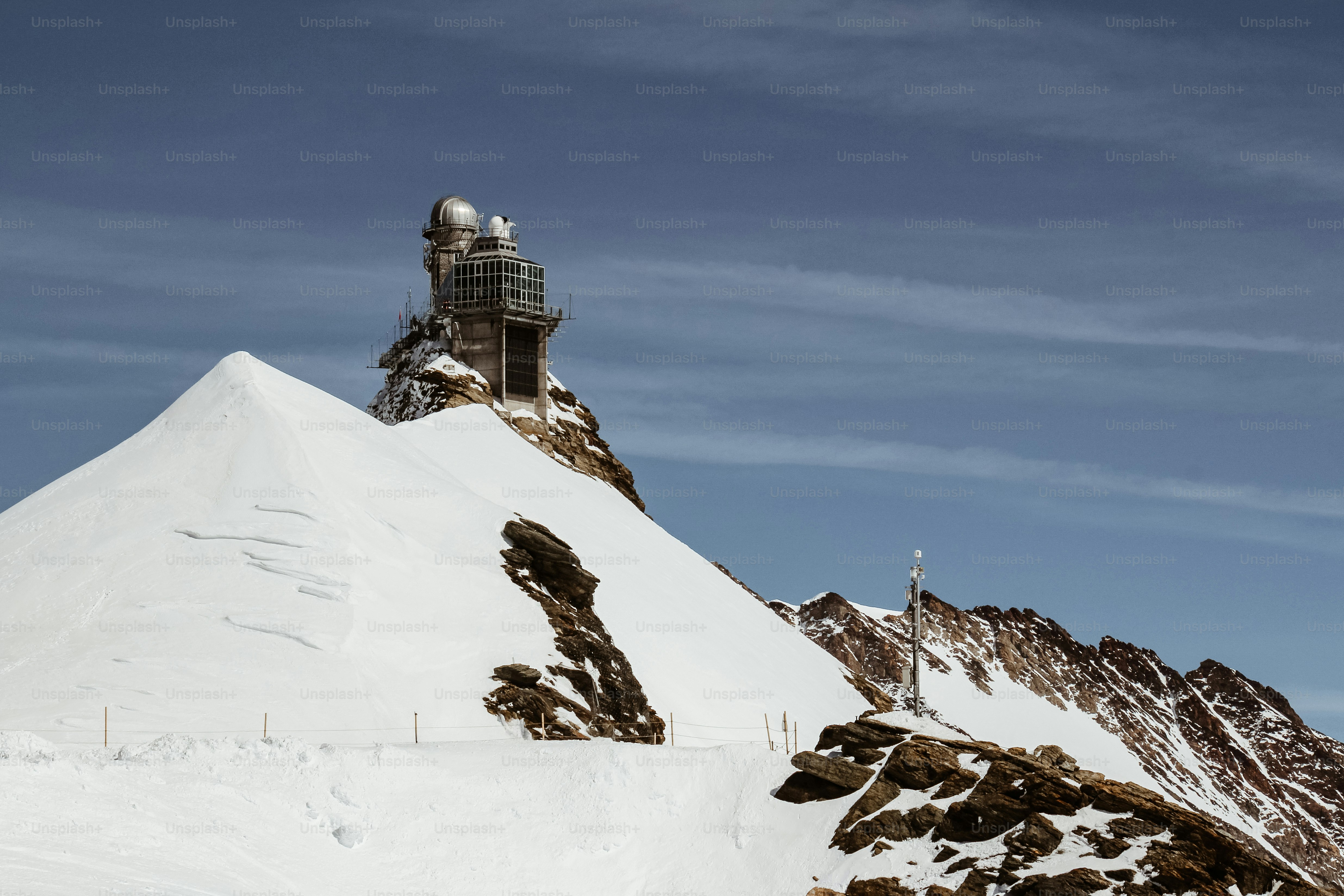A snowboarder is going down a snowy hill