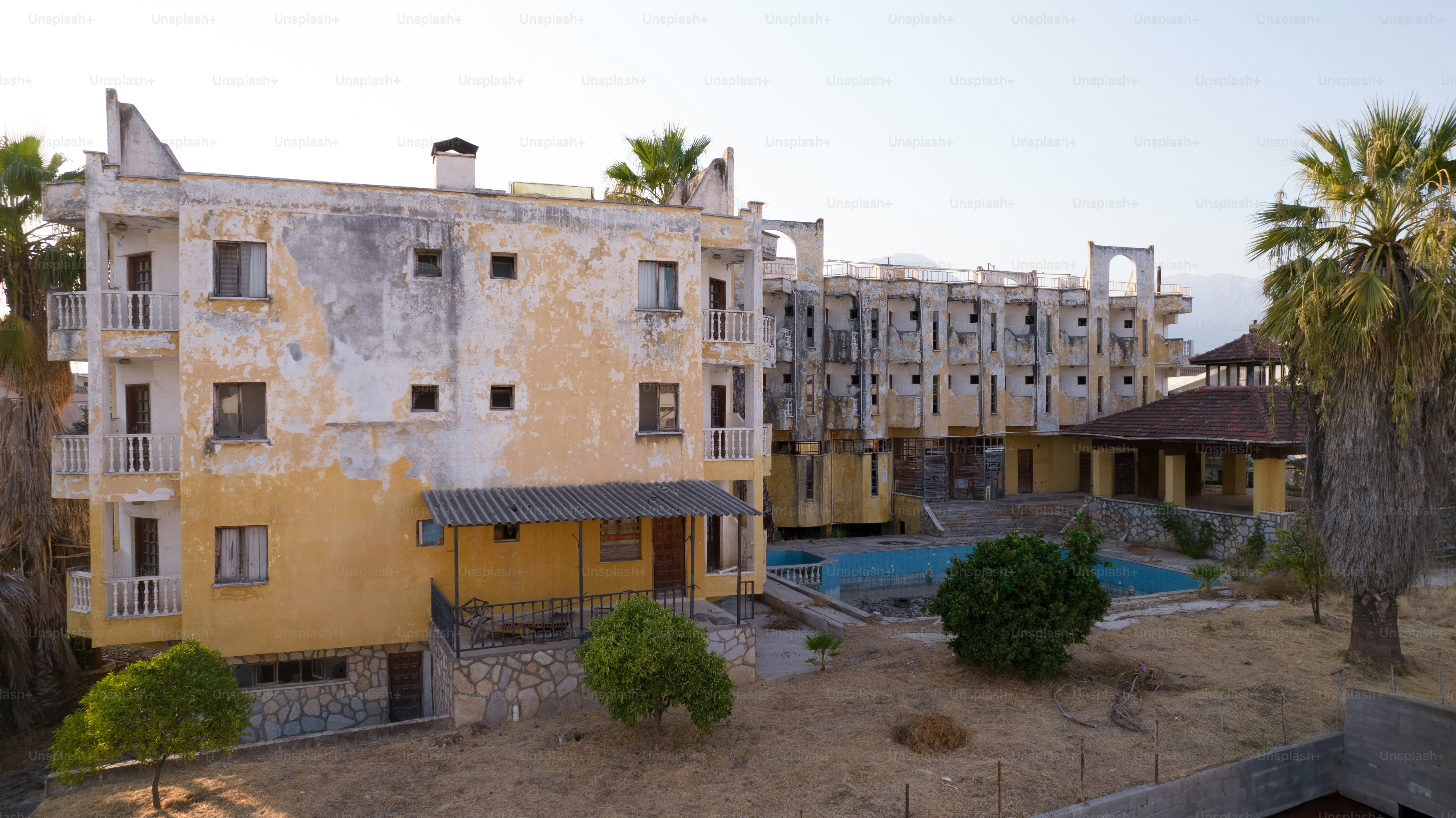 An old building with palm trees in front of it