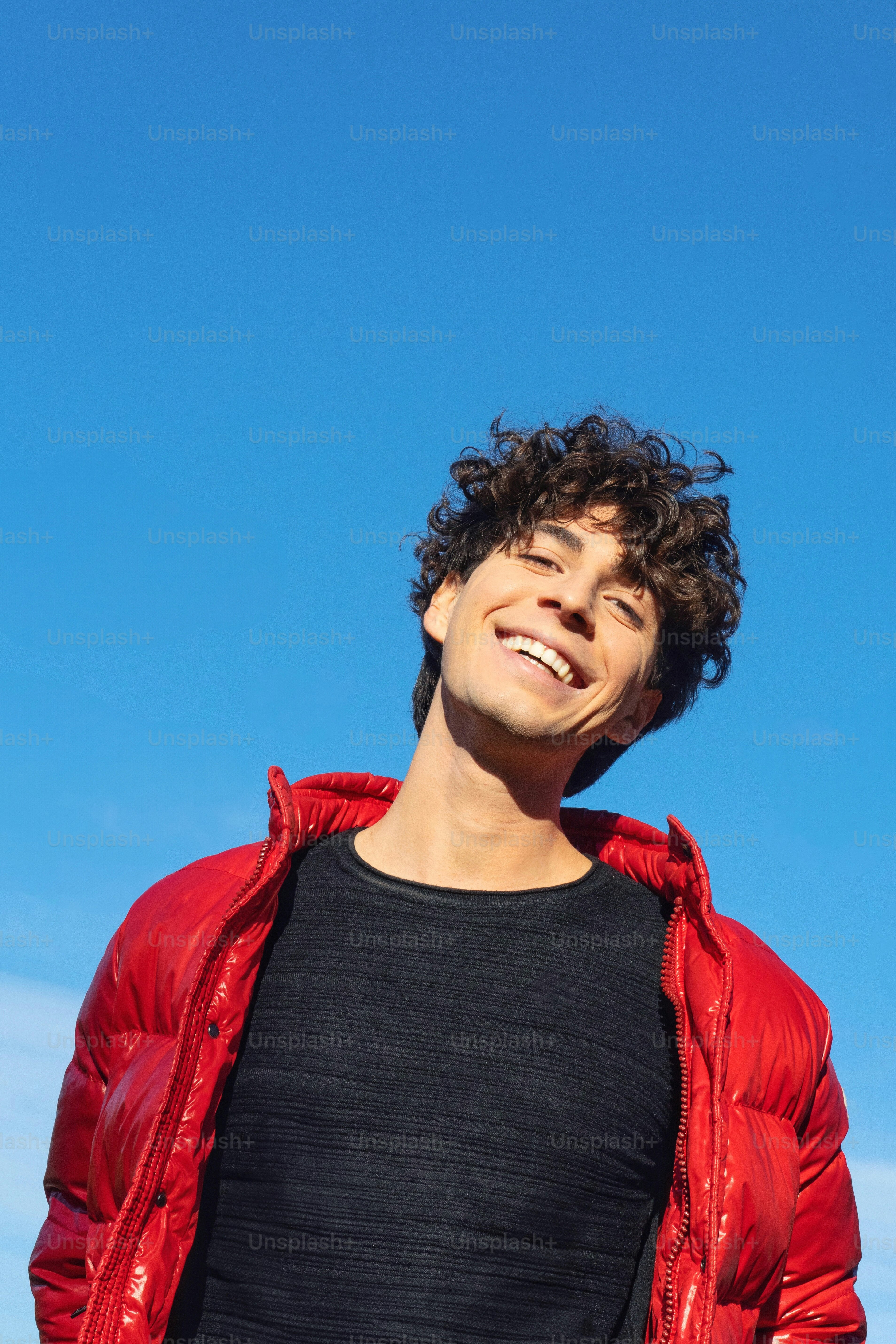A man in a black shirt and a red jacket