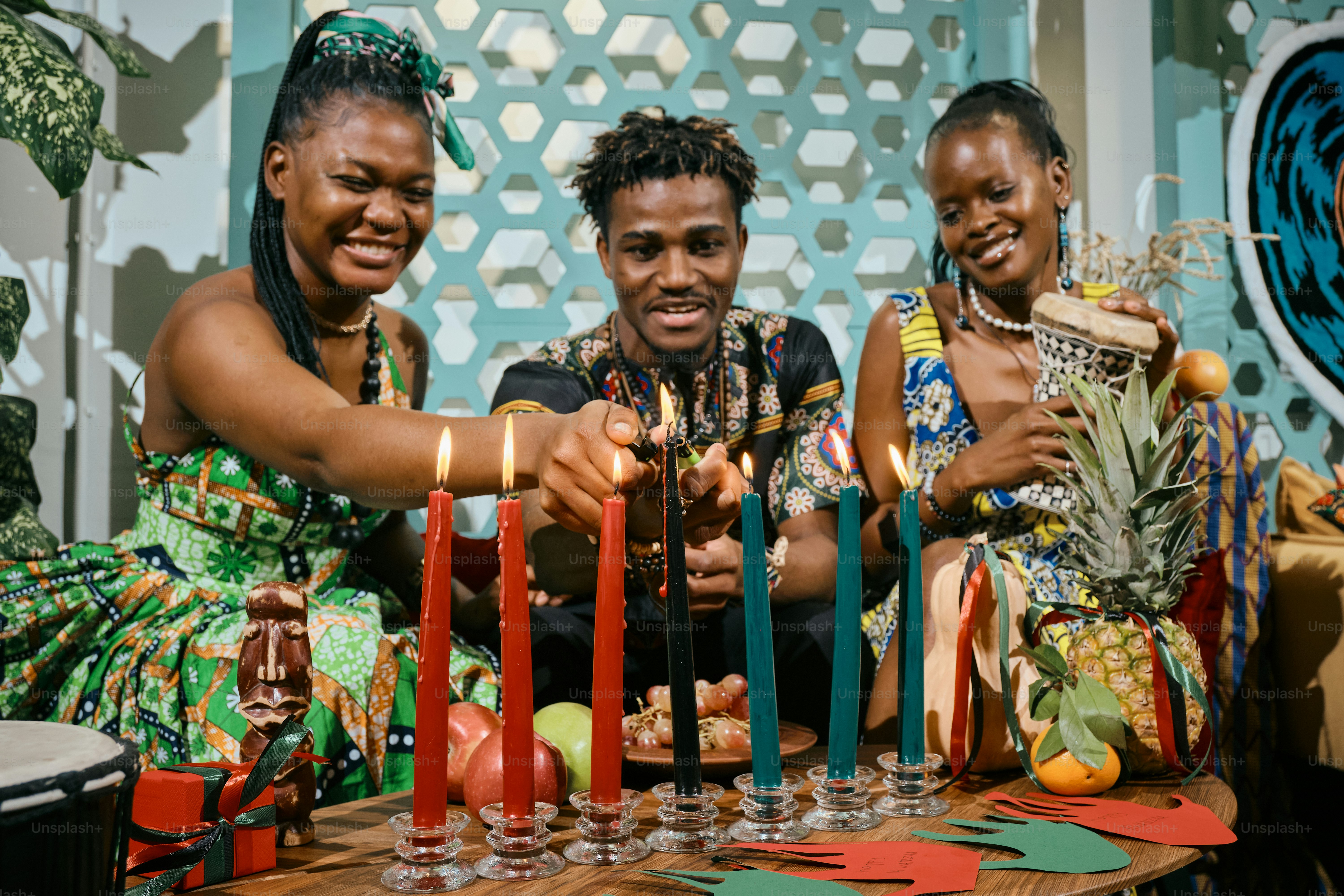 A group of people sitting around a table with candles
