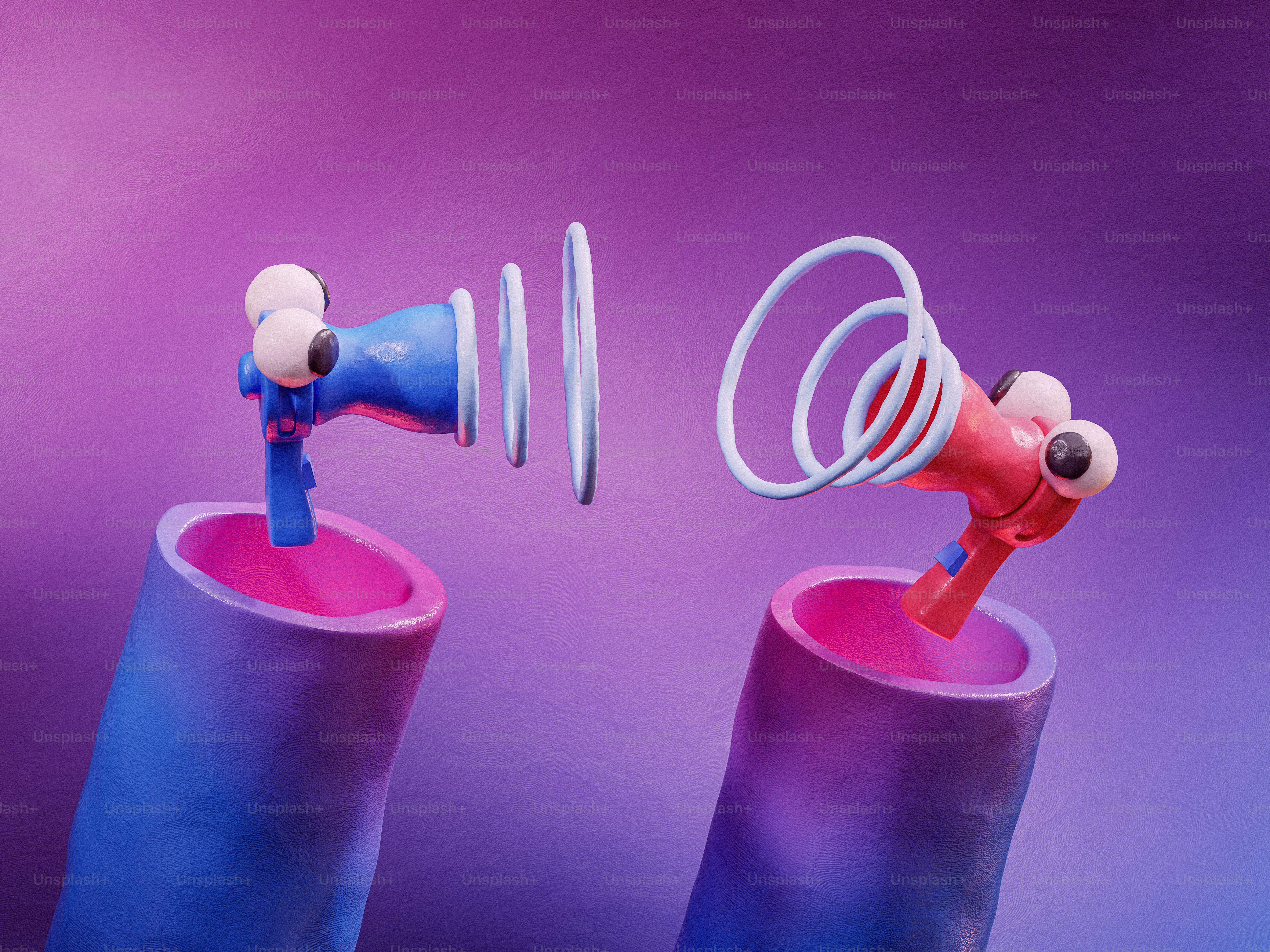 A pair of blue and pink earbuds sitting on top of each other