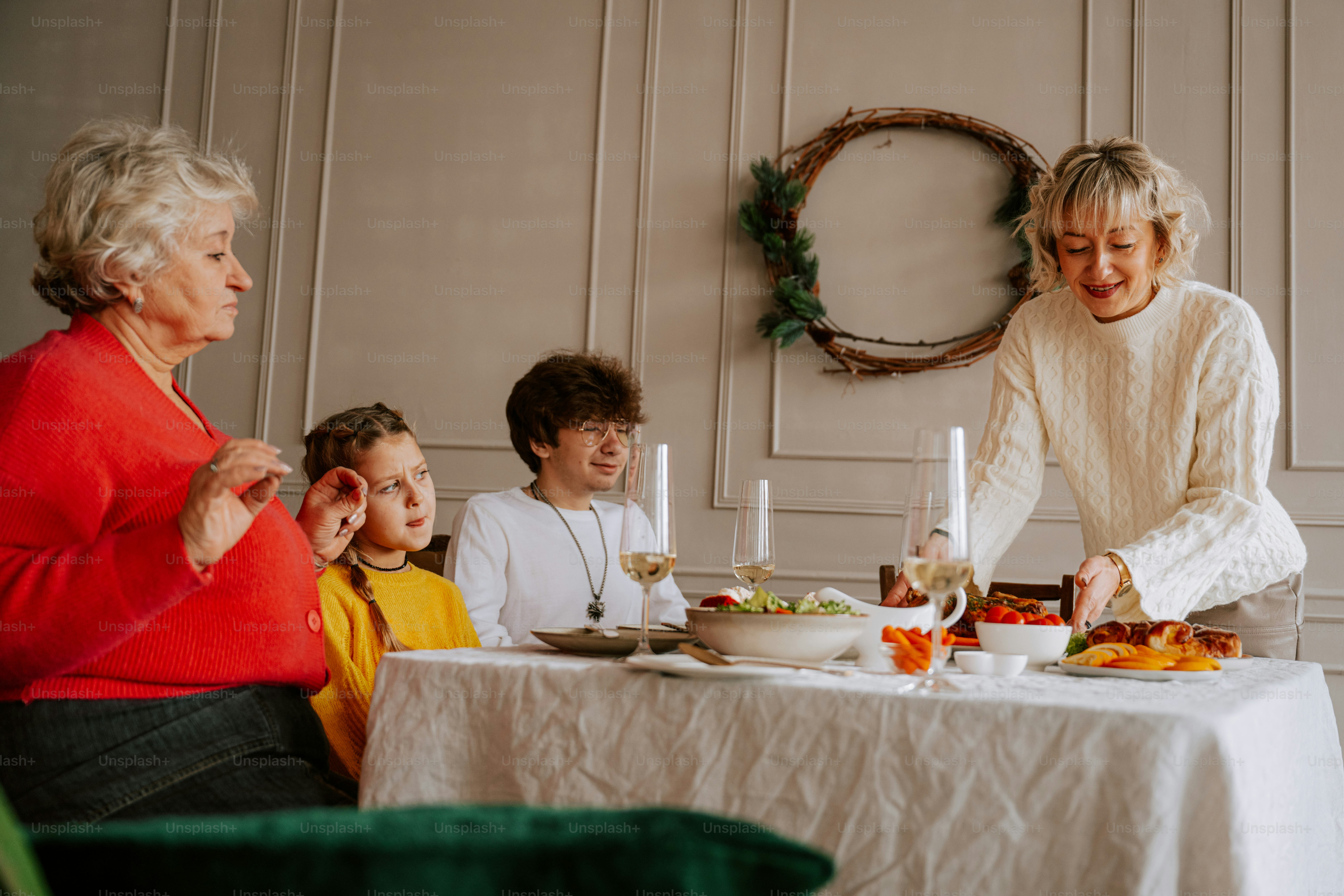 A group of people sitting around a table with food