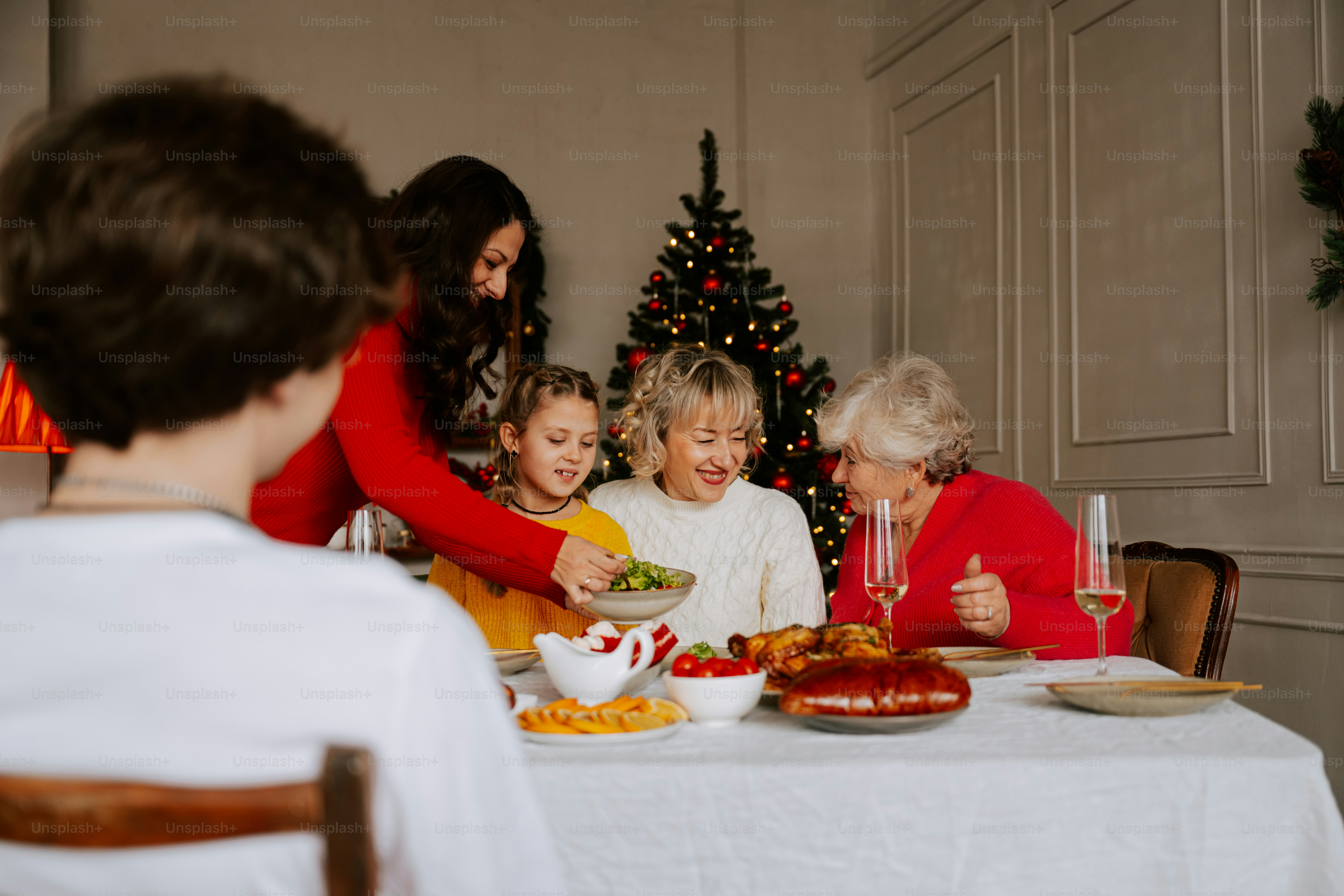 A group of people sitting around a table with food