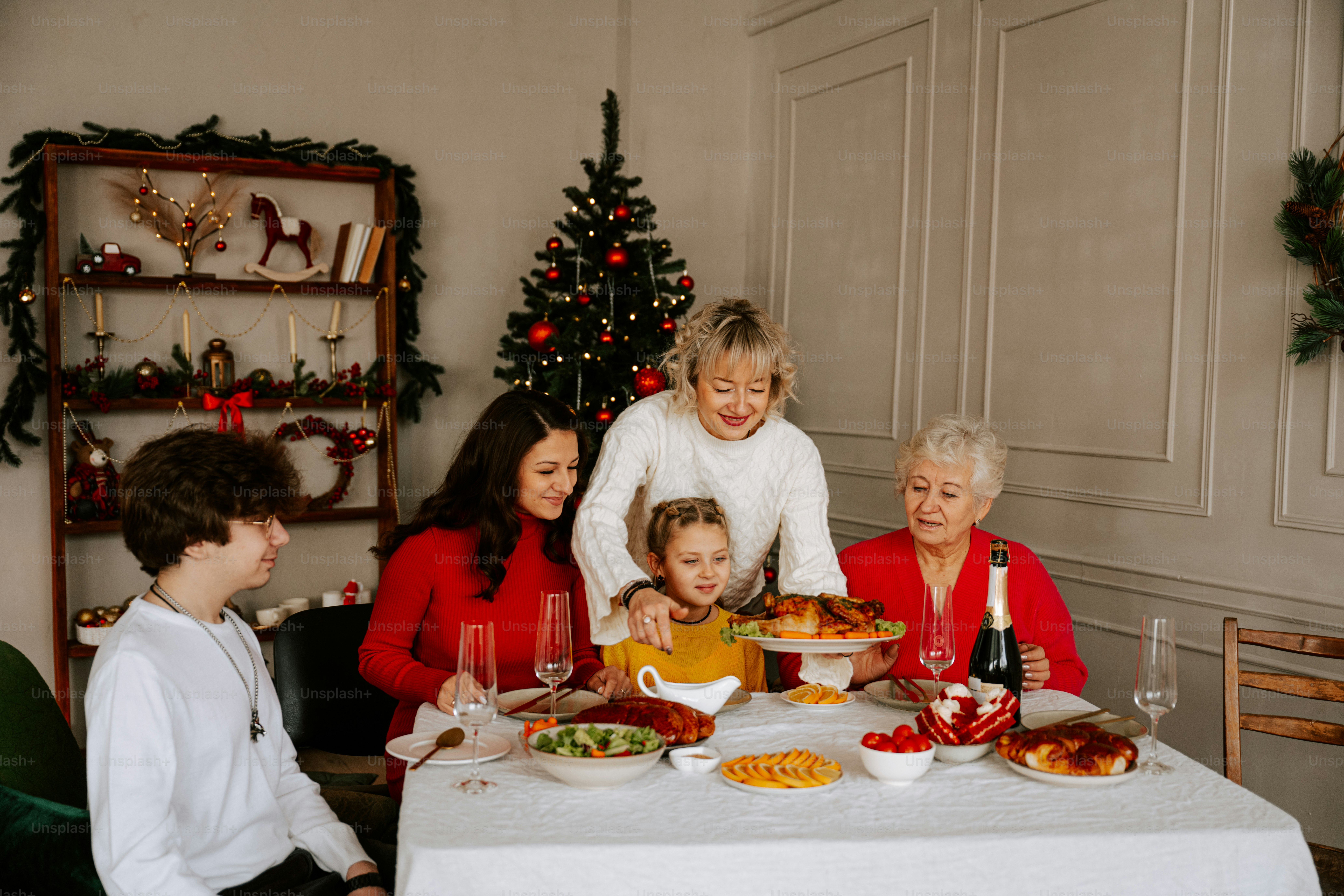 A group of people sitting around a table with food