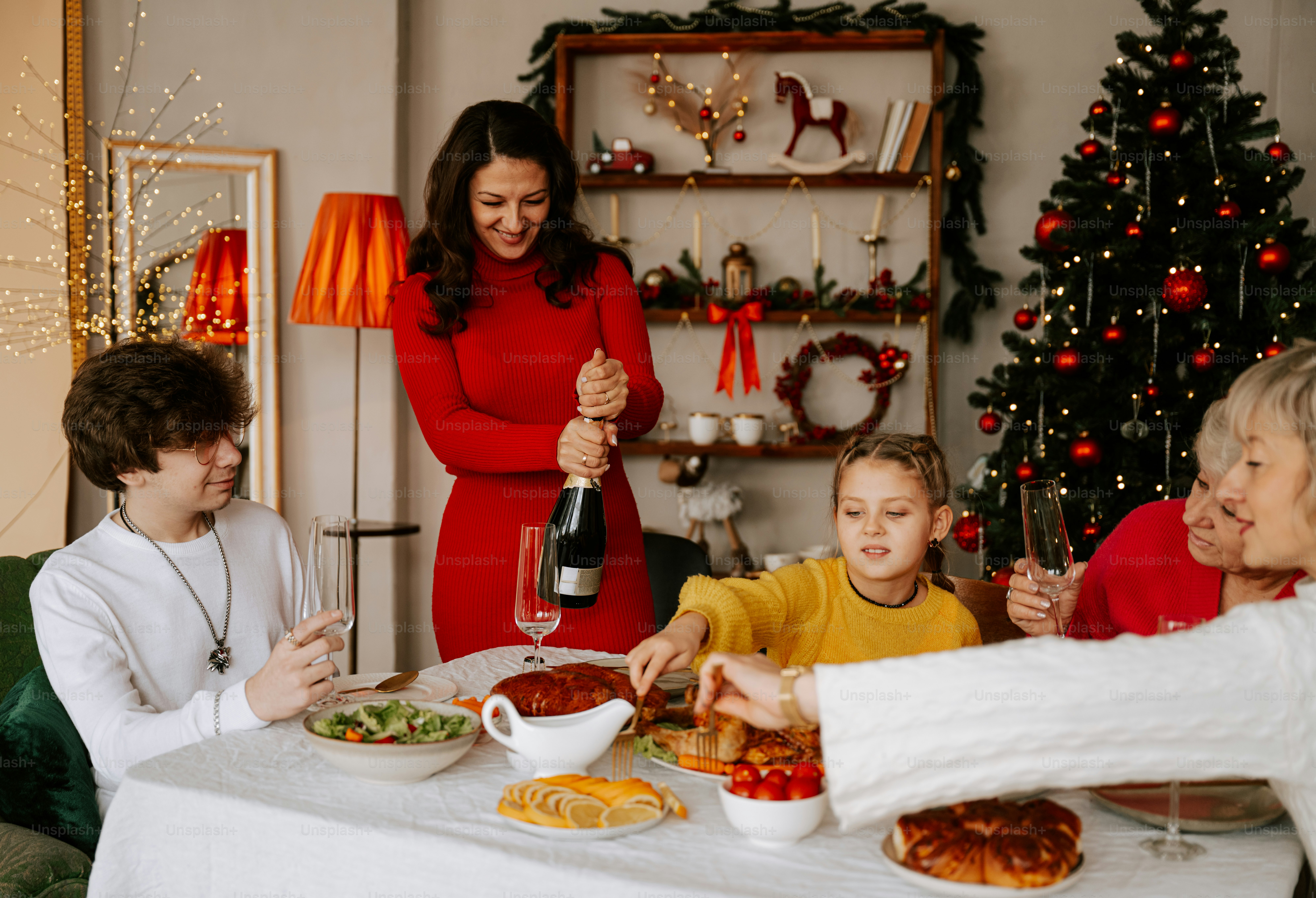 A group of people sitting around a table with food