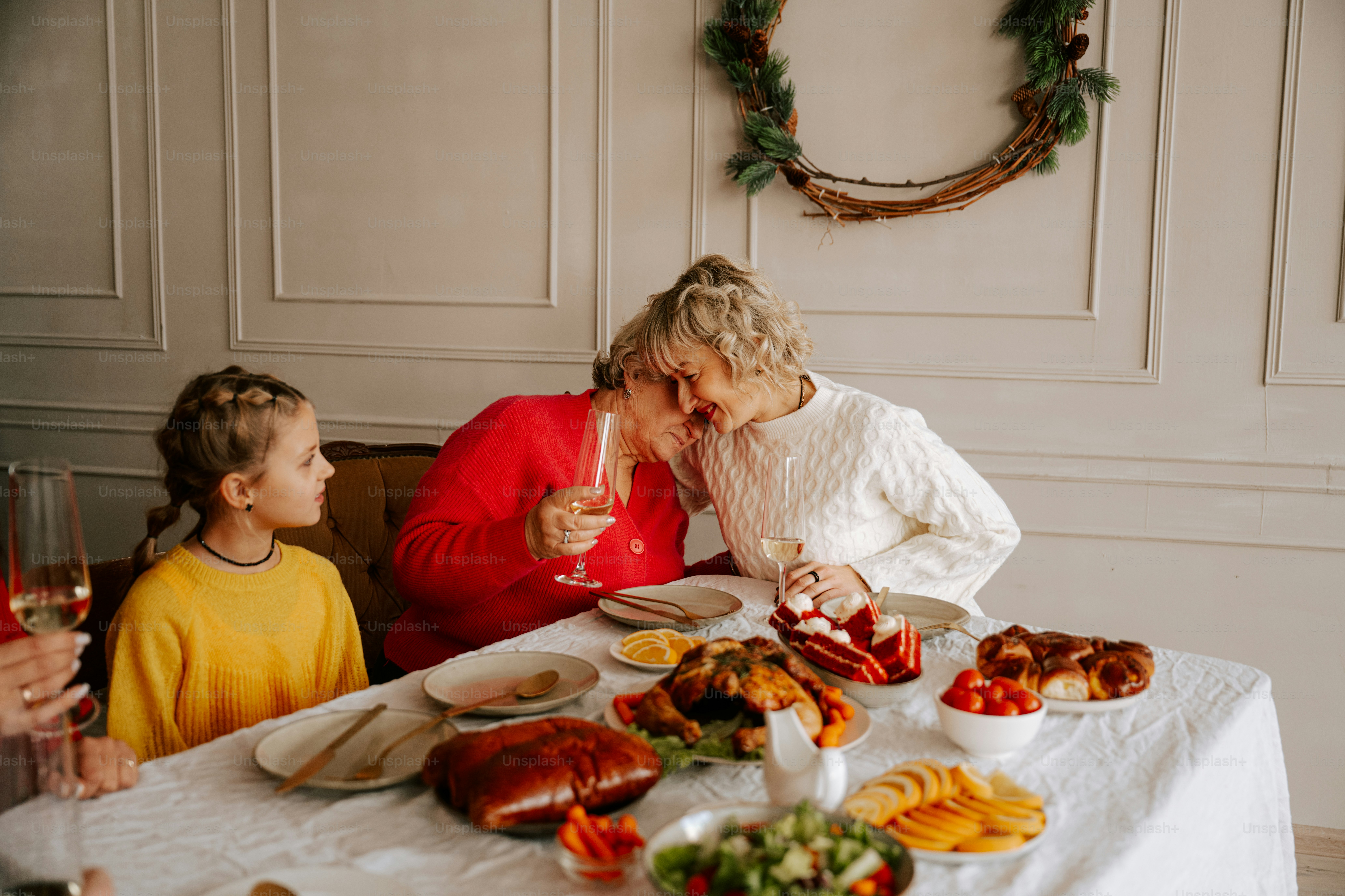 A couple of people sitting at a table with food