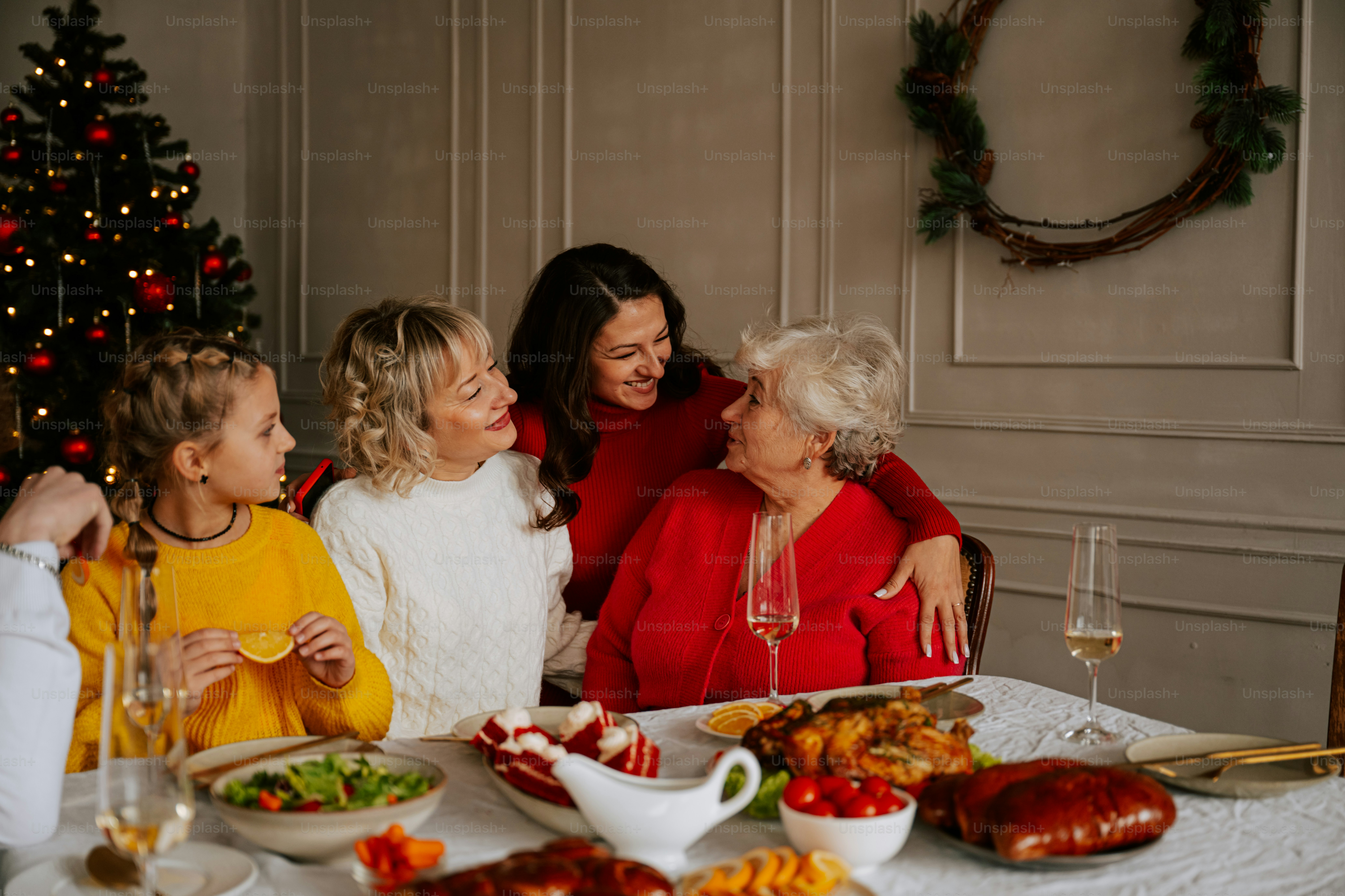 A group of women sitting around a table with food