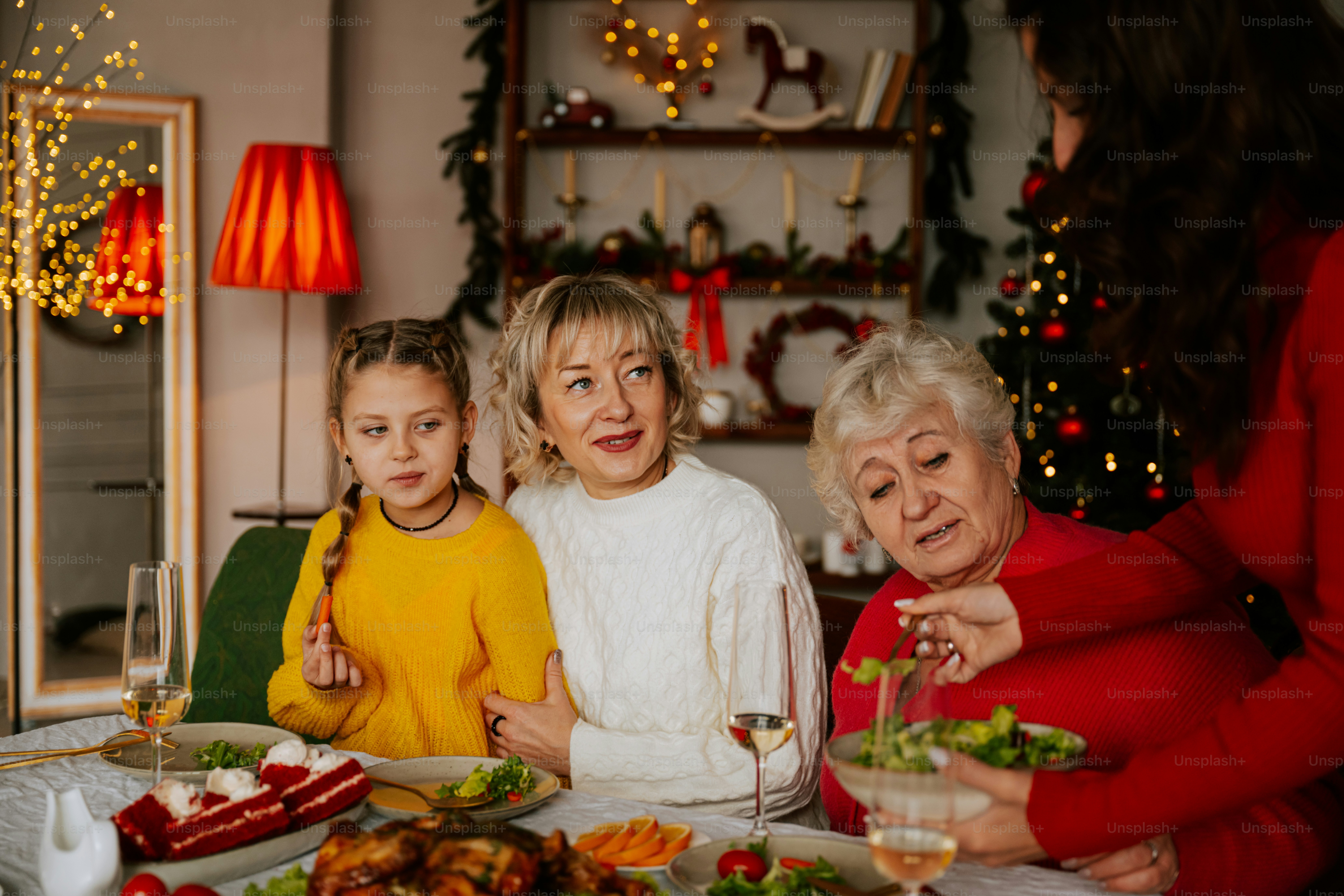 A group of women standing around a table with food