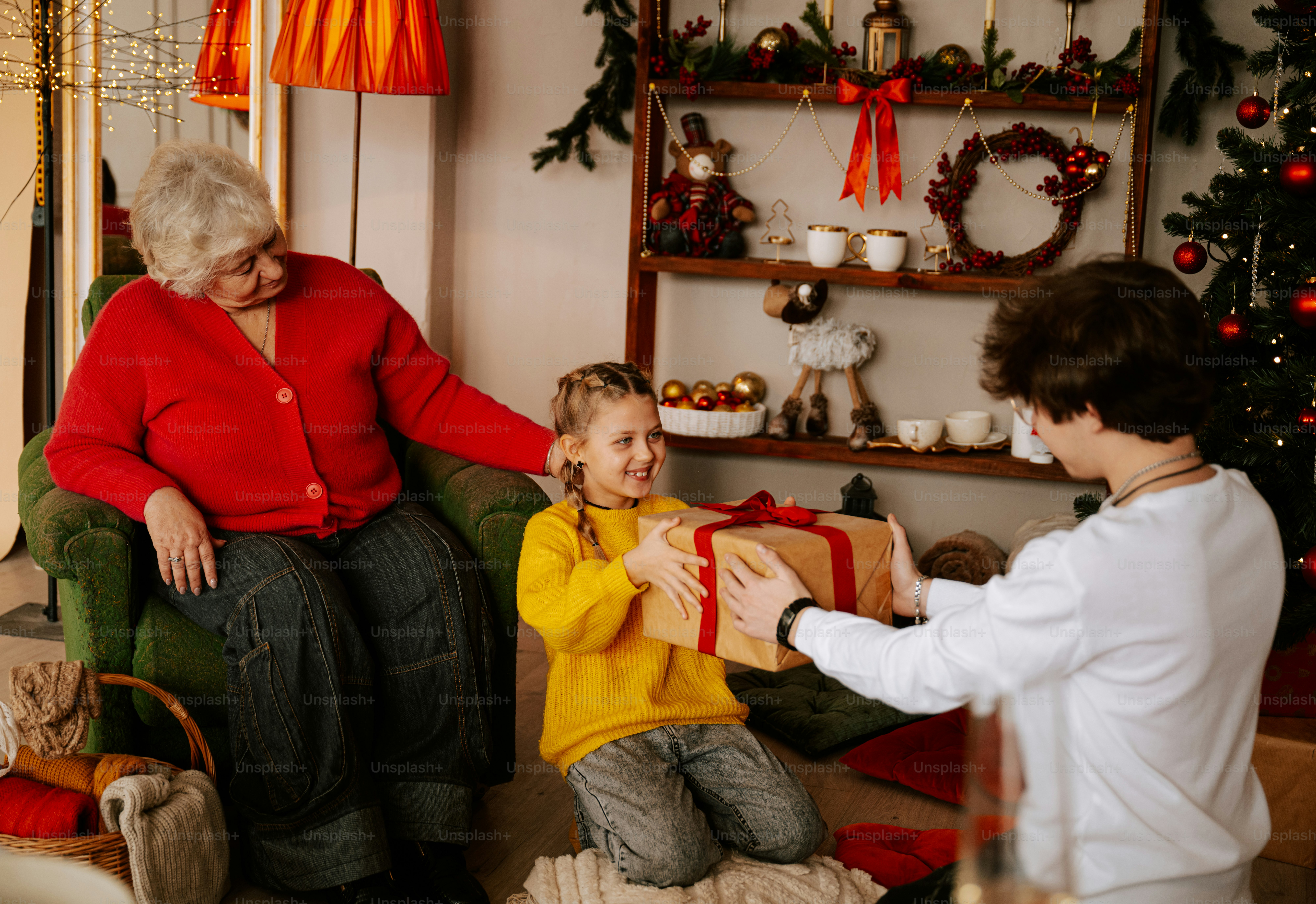 A little boy giving a present to an older woman