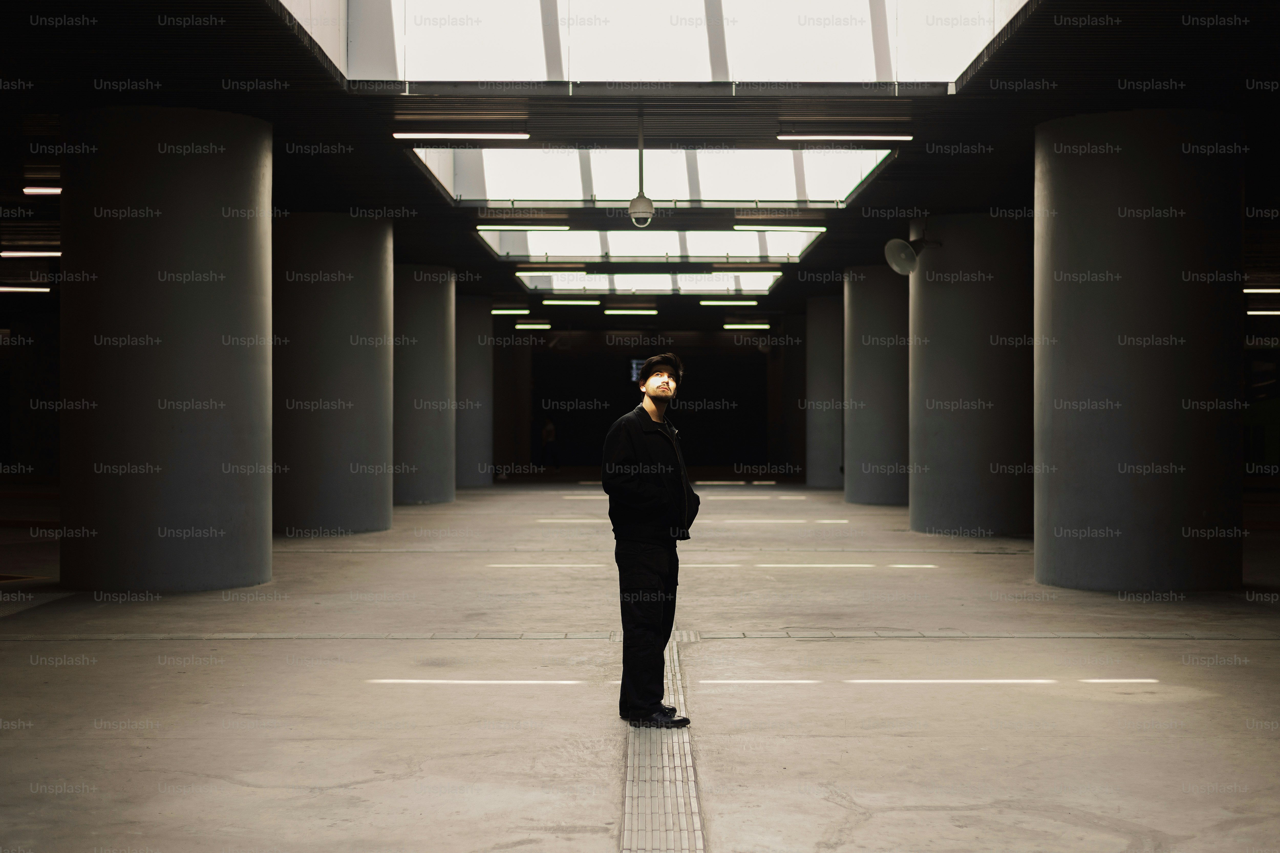 A man in a suit standing in an empty building