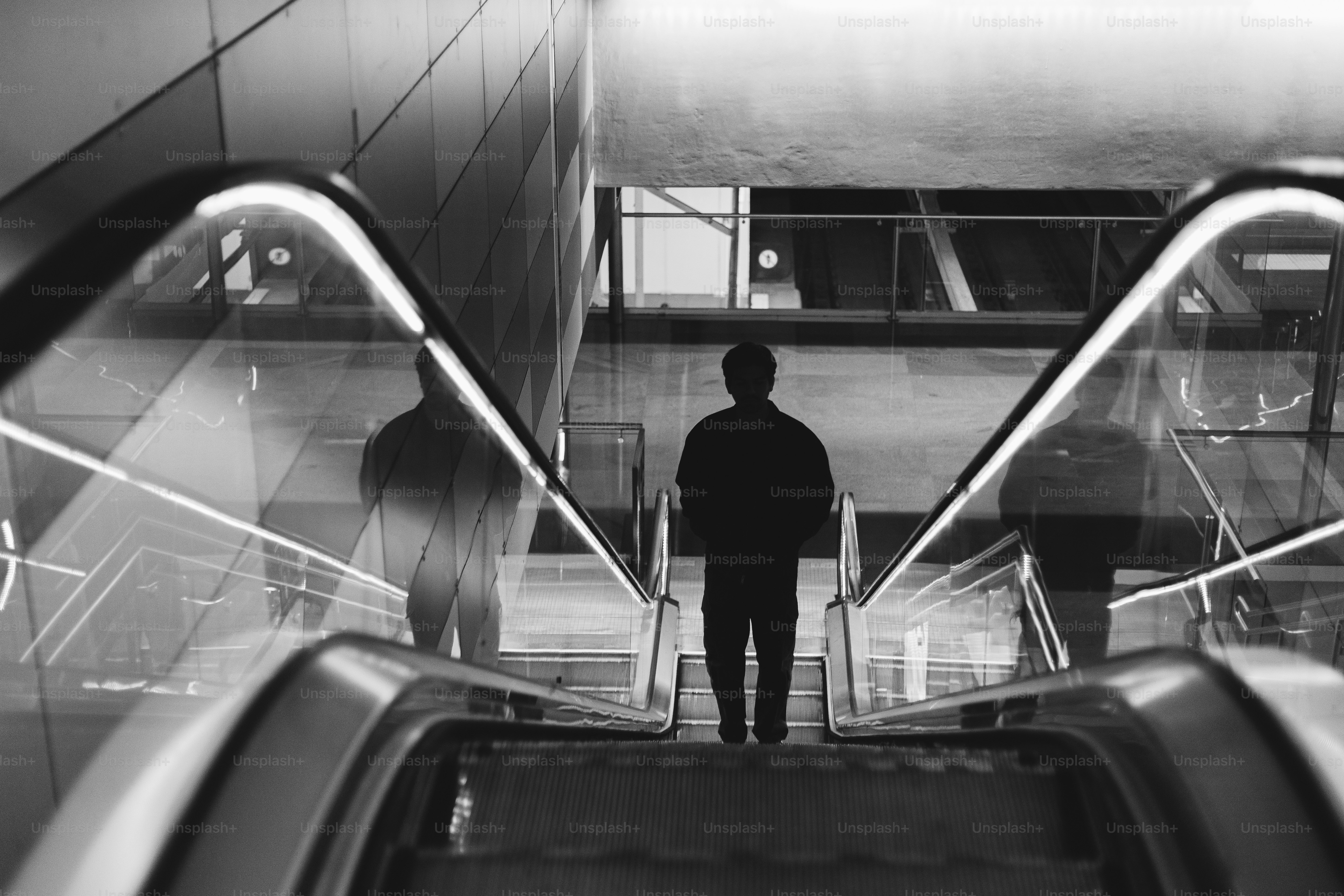 A man standing on an escalator in a building