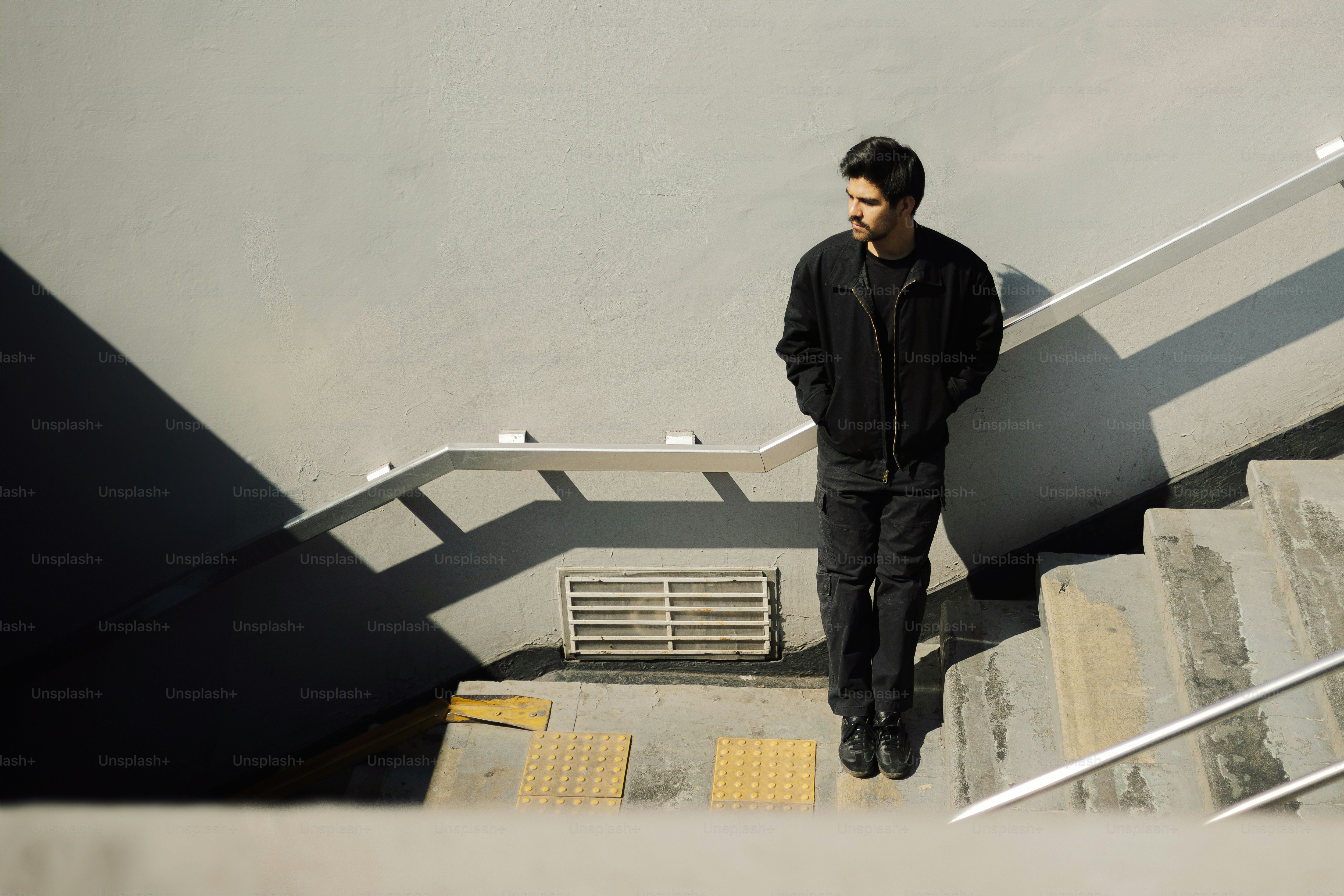 A man standing at the top of a flight of stairs